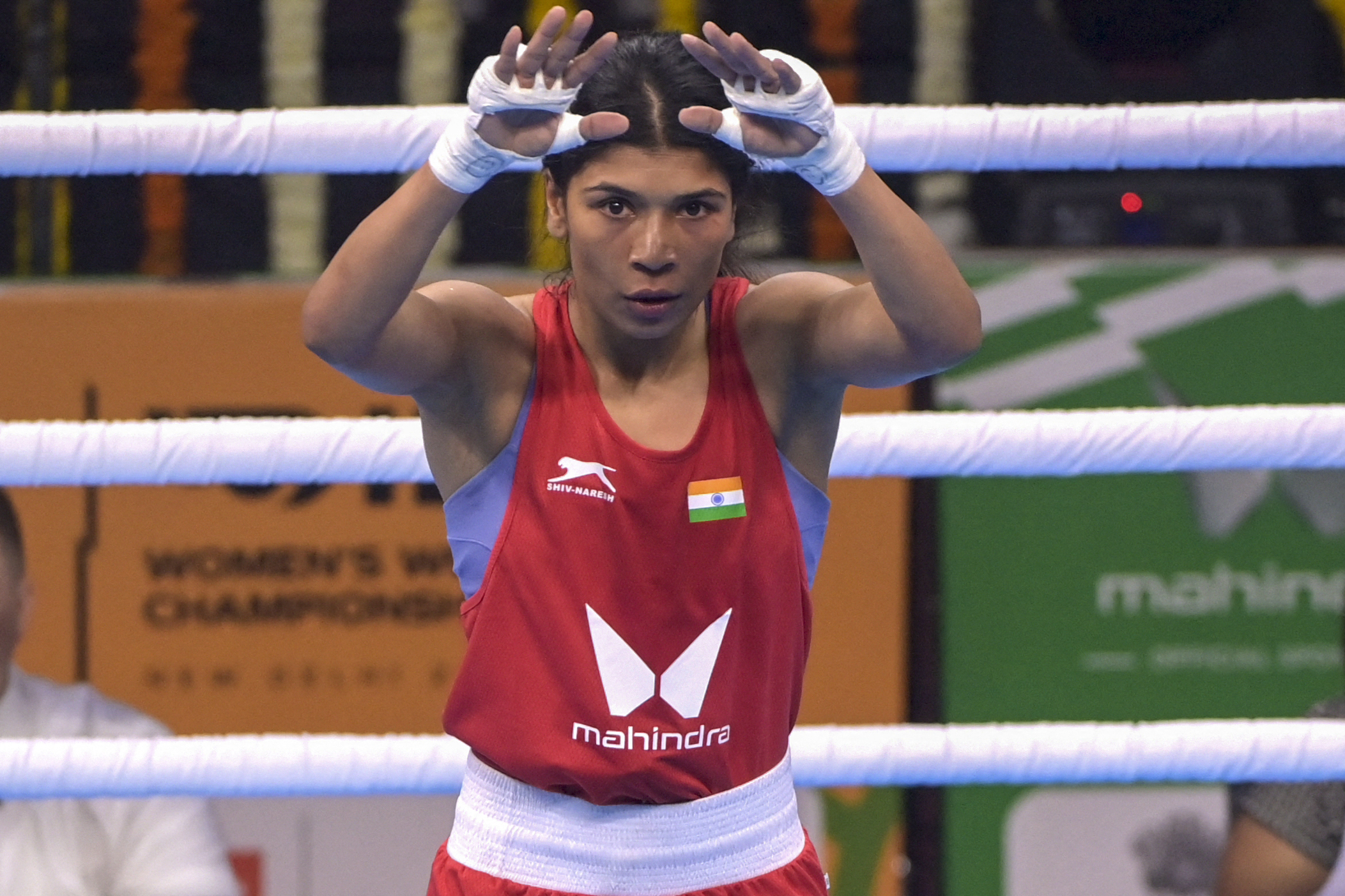 Nikhat Zareen waves to crowd at boxing match.