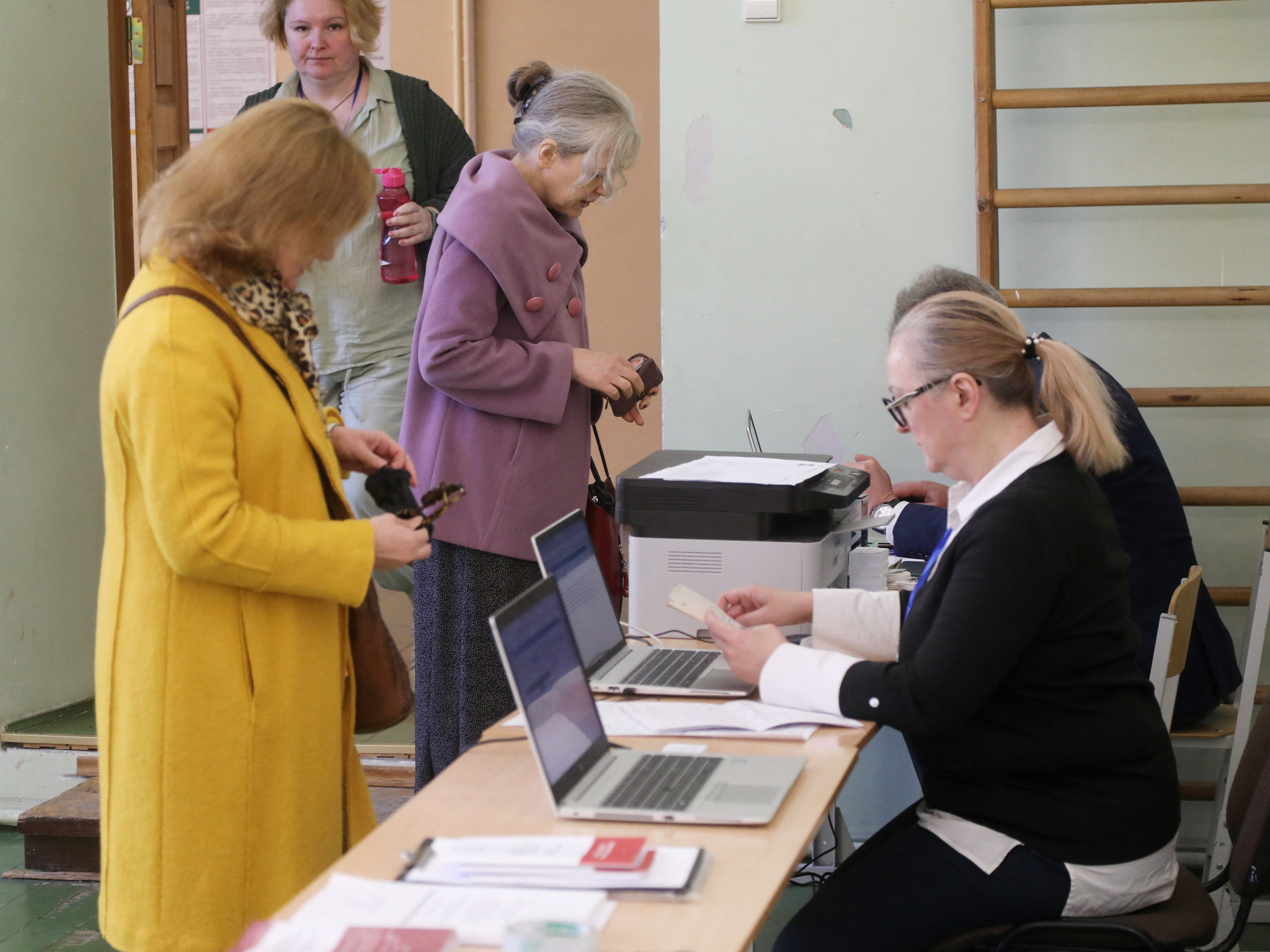 Voters arrive to get their ballot papers during the first round of Lithuania's presidential election at a polling station in Vilnius 