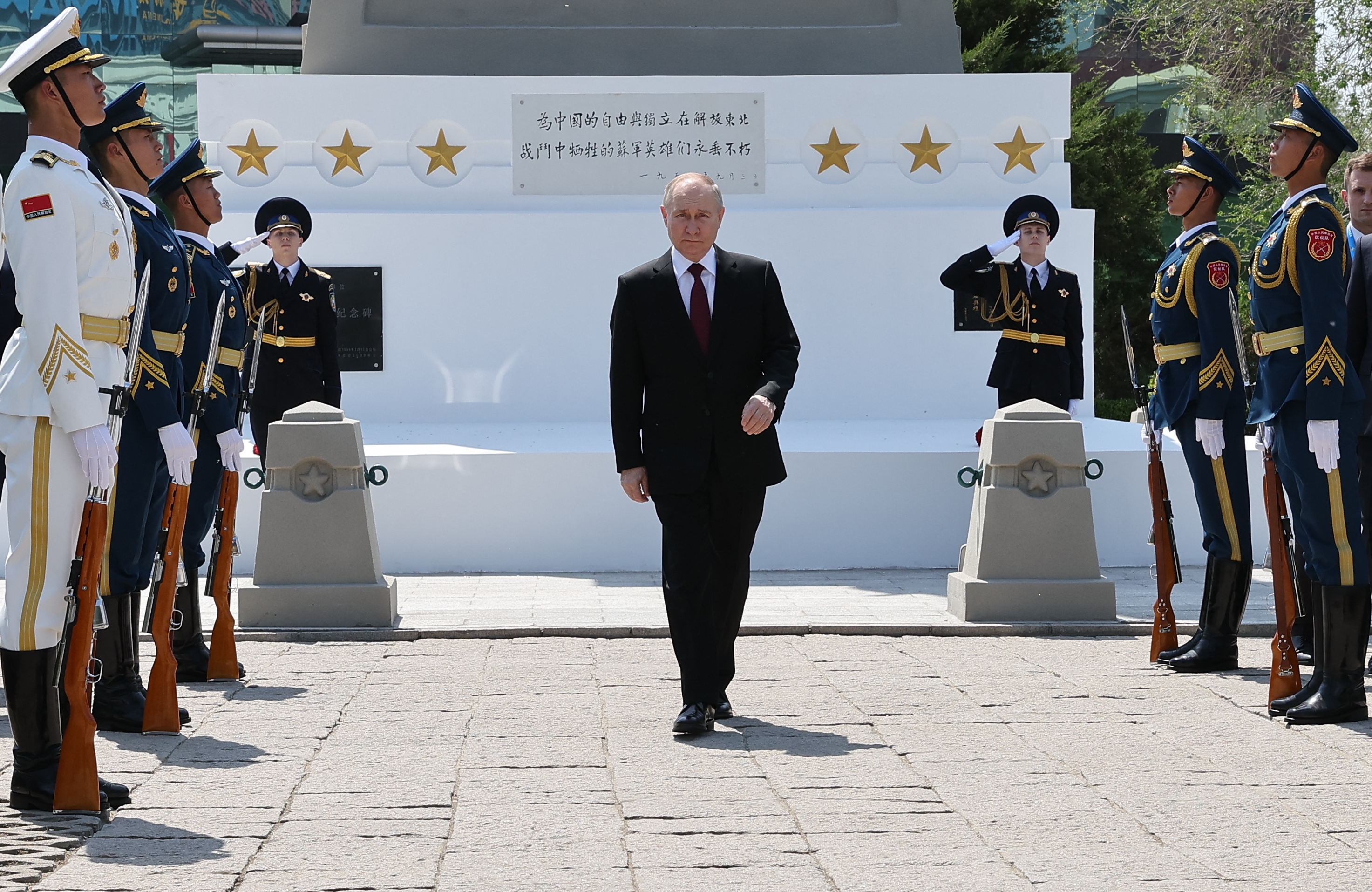 In this pool photograph distributed by the Russian state agency Sputnik, Russia's President Vladimir Putin lays flowers at the Soviet martyrs monument - built to commemorate the Soviet Red Army soldiers who died during World War II, in the northeastern city of Harbin on May 17, 2024. (Photo by Alexander RYUMIN / POOL / AFP) / ** EDITOR'S NOTE : THIS IMAGE IS DISTRIBUTED BY RUSSIAN STATE OWNED AGENCY SPUTNIK **