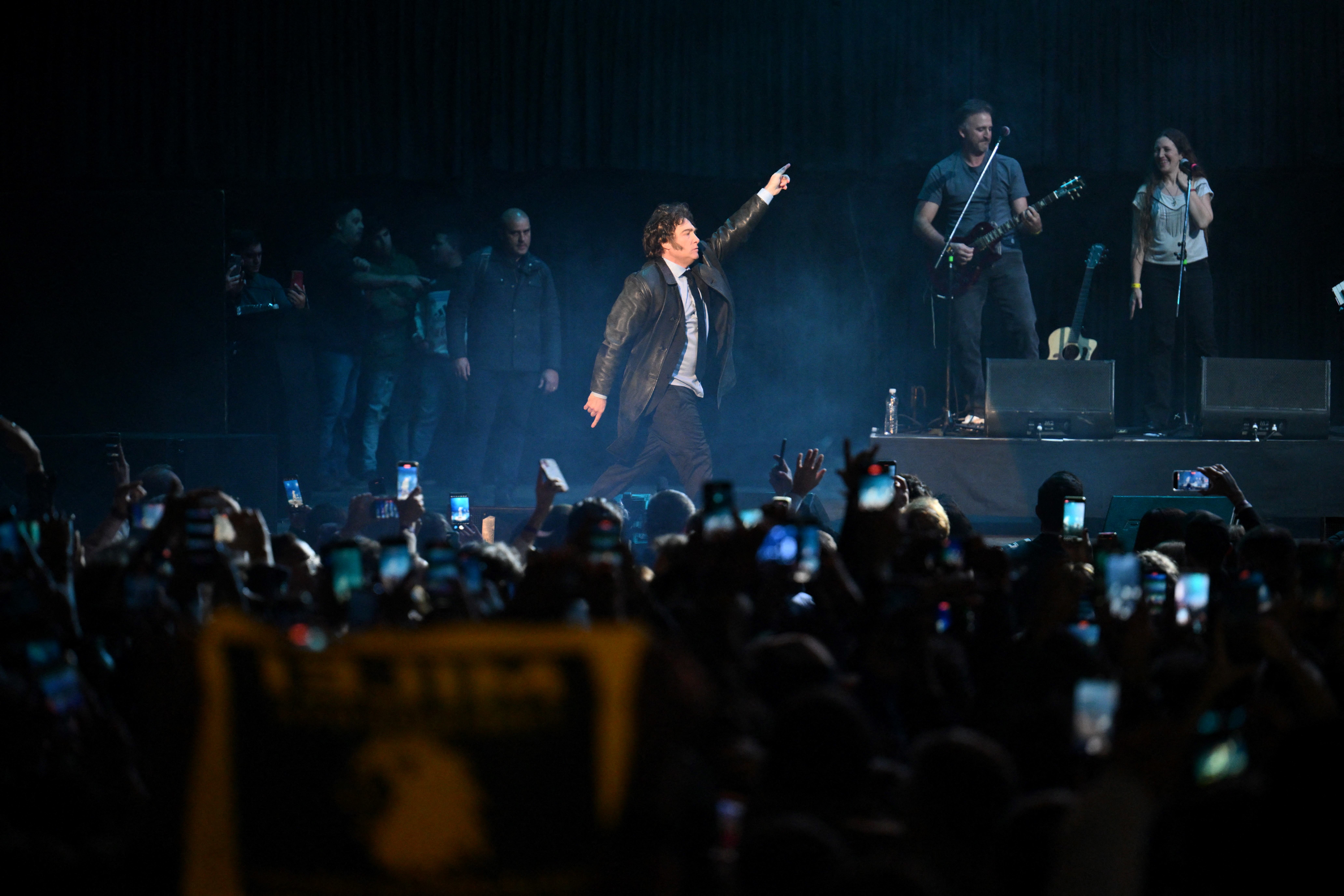 Argentine President Javier Milei (C) dances during the presentation of his new book "Capitalism, Socialism, and the Neoclassical Trap" at the Luna Park stadium in Buenos Aires on May 22