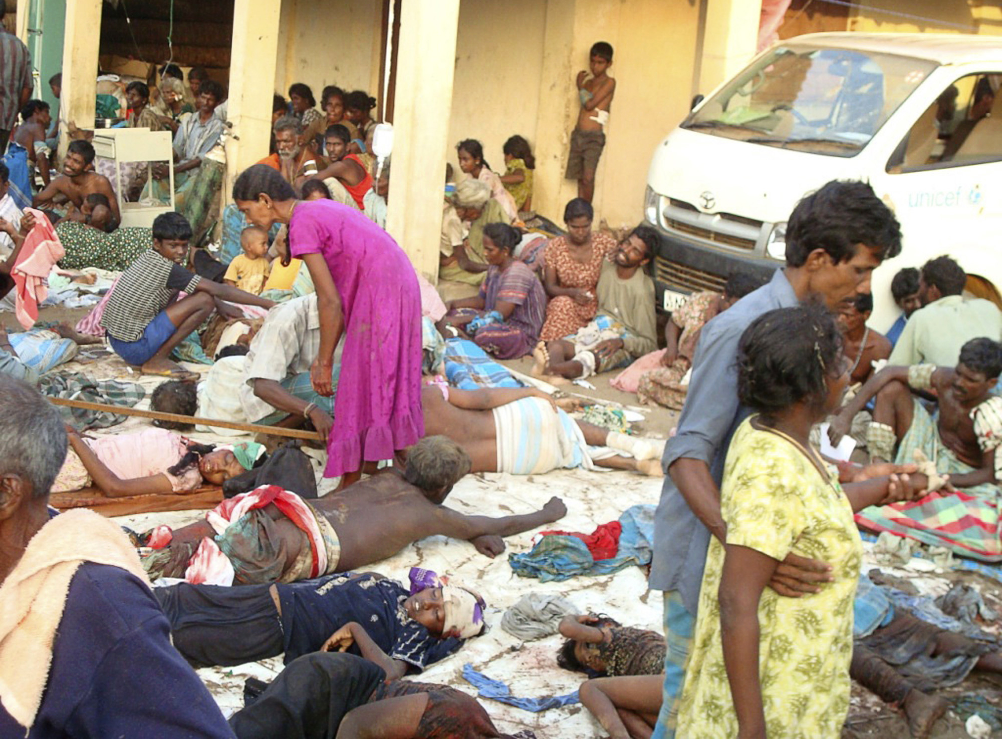 EDS NOTE : GRAPHIC CONTENT - FILE - In this May 10, 2009 file photo, Sri Lankan ethnic Tamil victims of a shell attack wait outside a makeshift hospital in Tiger controlled No Fire Zone in Mullivaaykaal, Sri Lanka. A Sri Lankan man was wounded in the final months of the country's bloody civil war by an unexploded cluster bomblet that tore into his leg, a medical worker who saw the injury told The Associated Press on Friday, April 27, 2012. The revelation, along with a photograph that purports to show the wound, added further credence to accusations cluster munitions had been used during the final months of the war. The government has repeatedly denied using cluster munitions during the final months of fighting. (AP Photo/File)