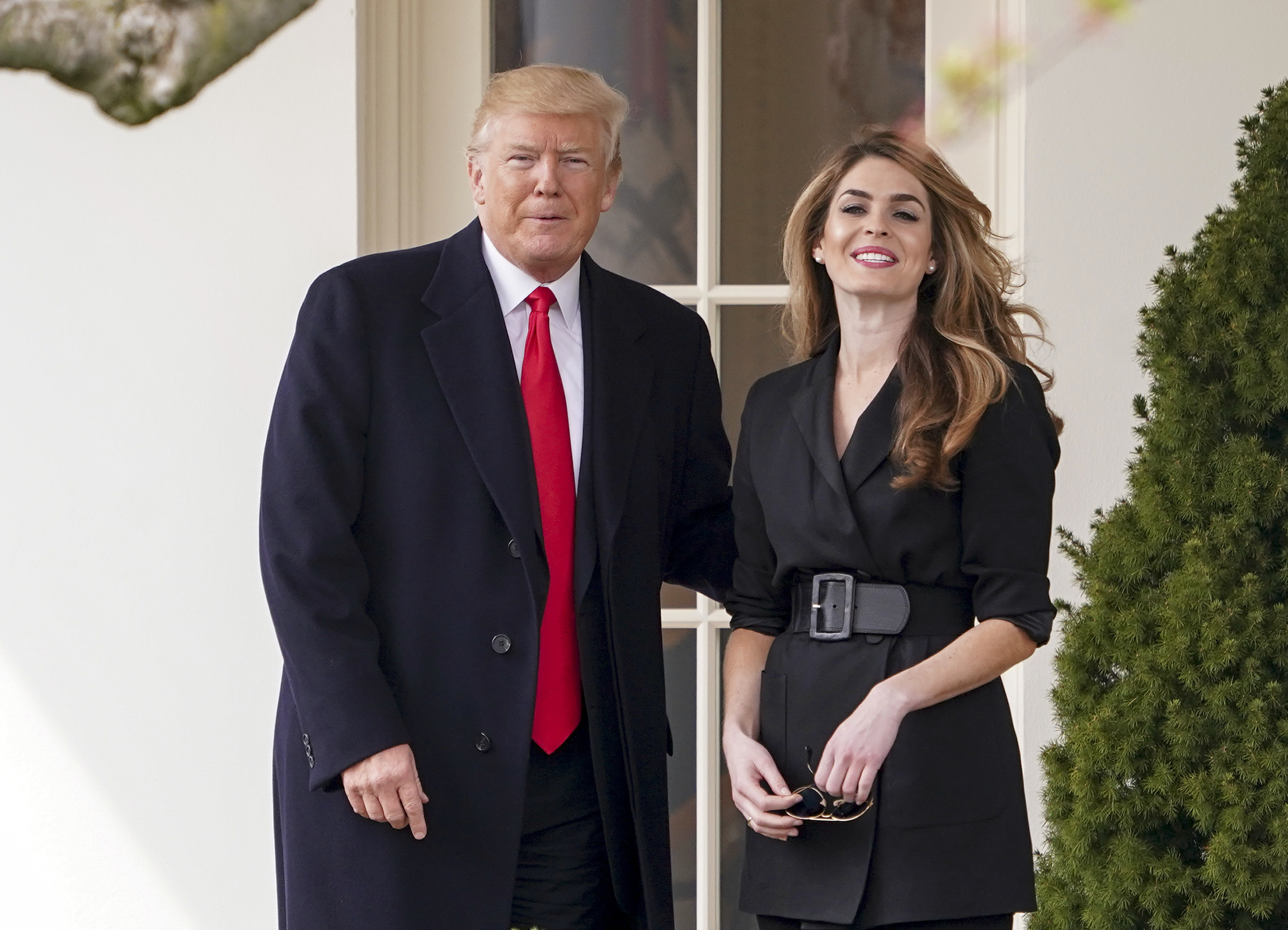 Donald Trump stands with Hope Hicks outside of the White House.