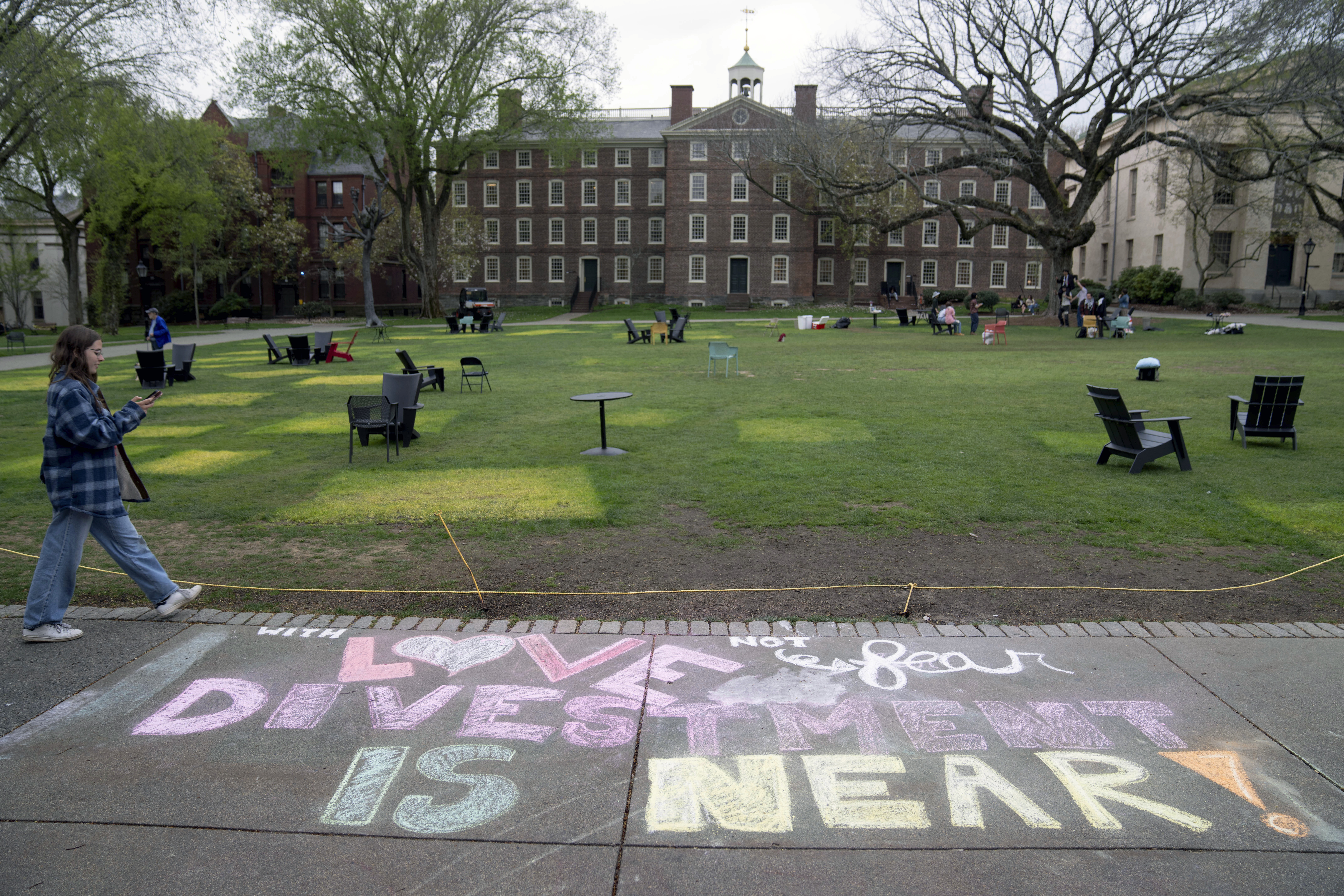 A message in chalk decorates a sidewalk after an encampment protesting the Israel-Hamas war was taken down at Brown University,