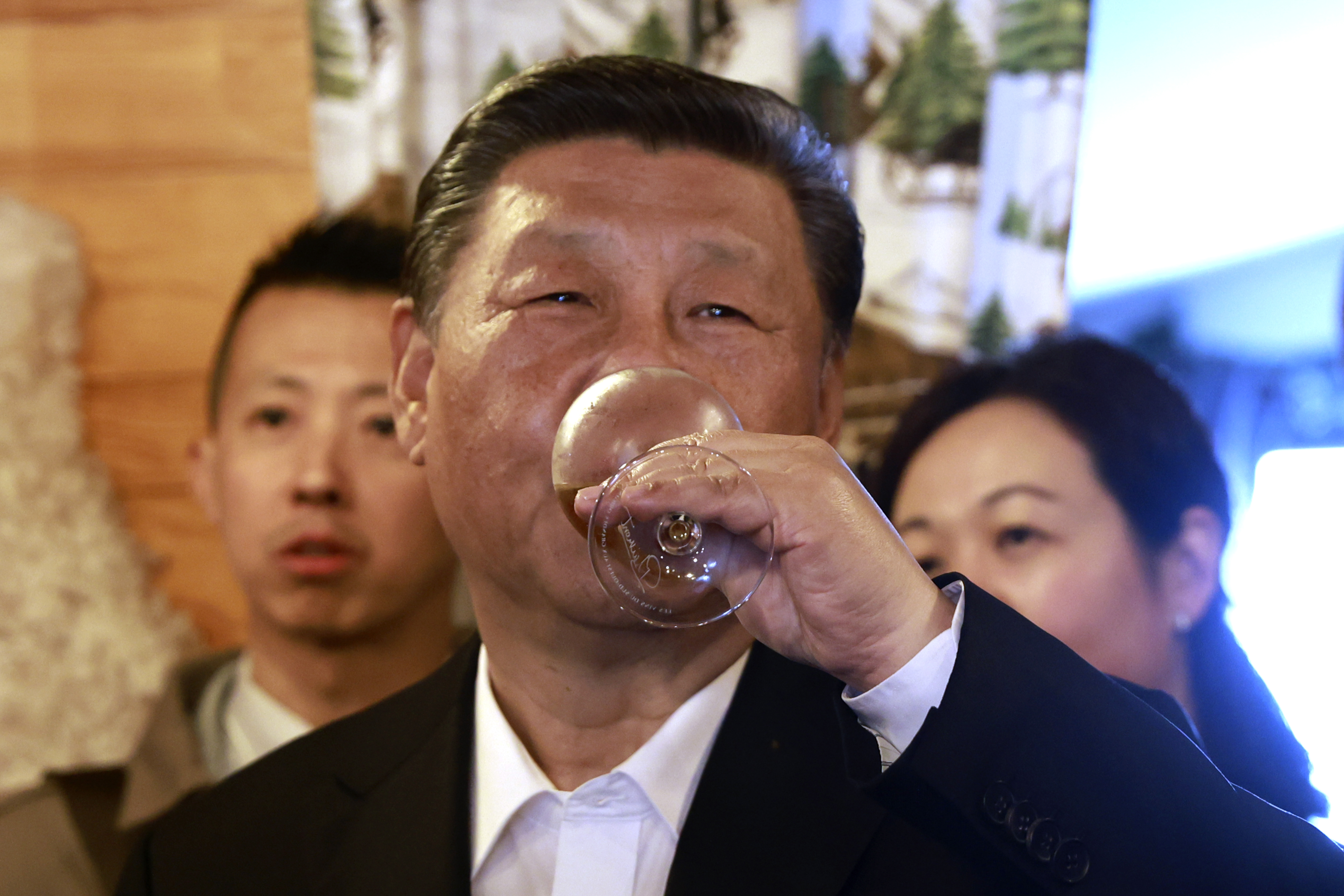 Xi Jinping enjoying a glad of wine in France. He looks happy and relaxed.