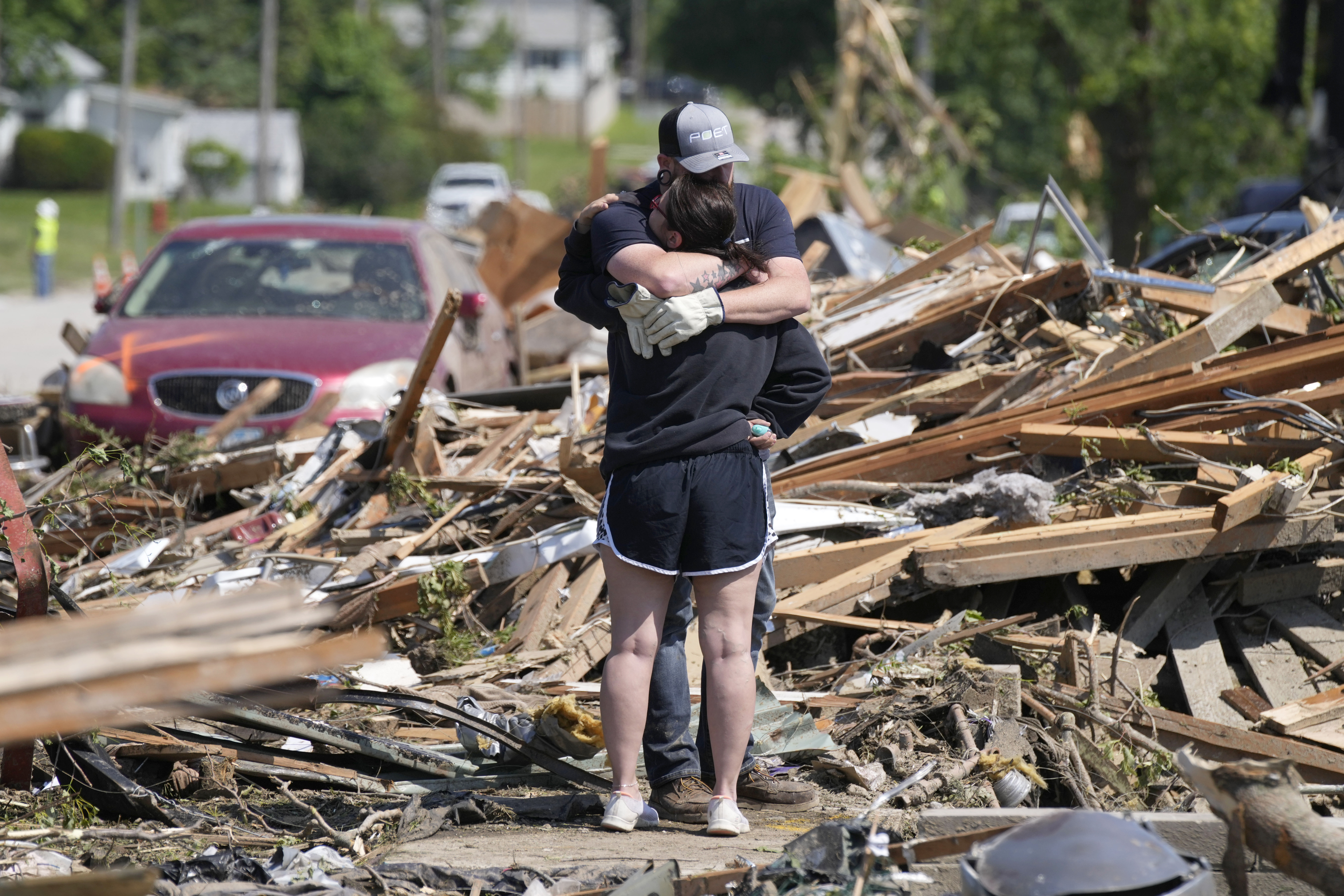 Local residents hug in front of their tornado damaged home, Wednesday, May 22, 2024, in Greenfield, Iowa