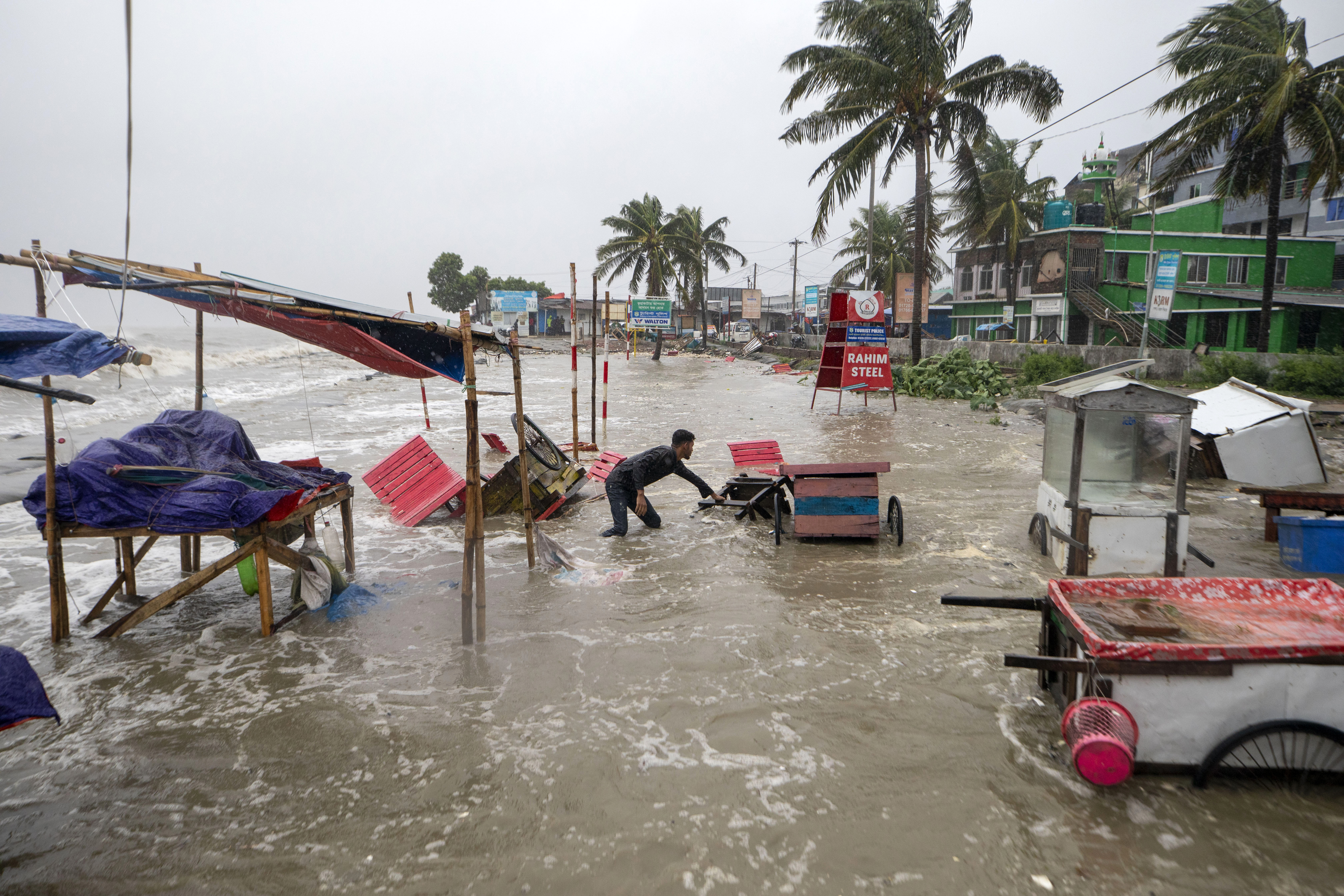 Cyclone blows away thatched roofs and cuts power in Bangladesh and India