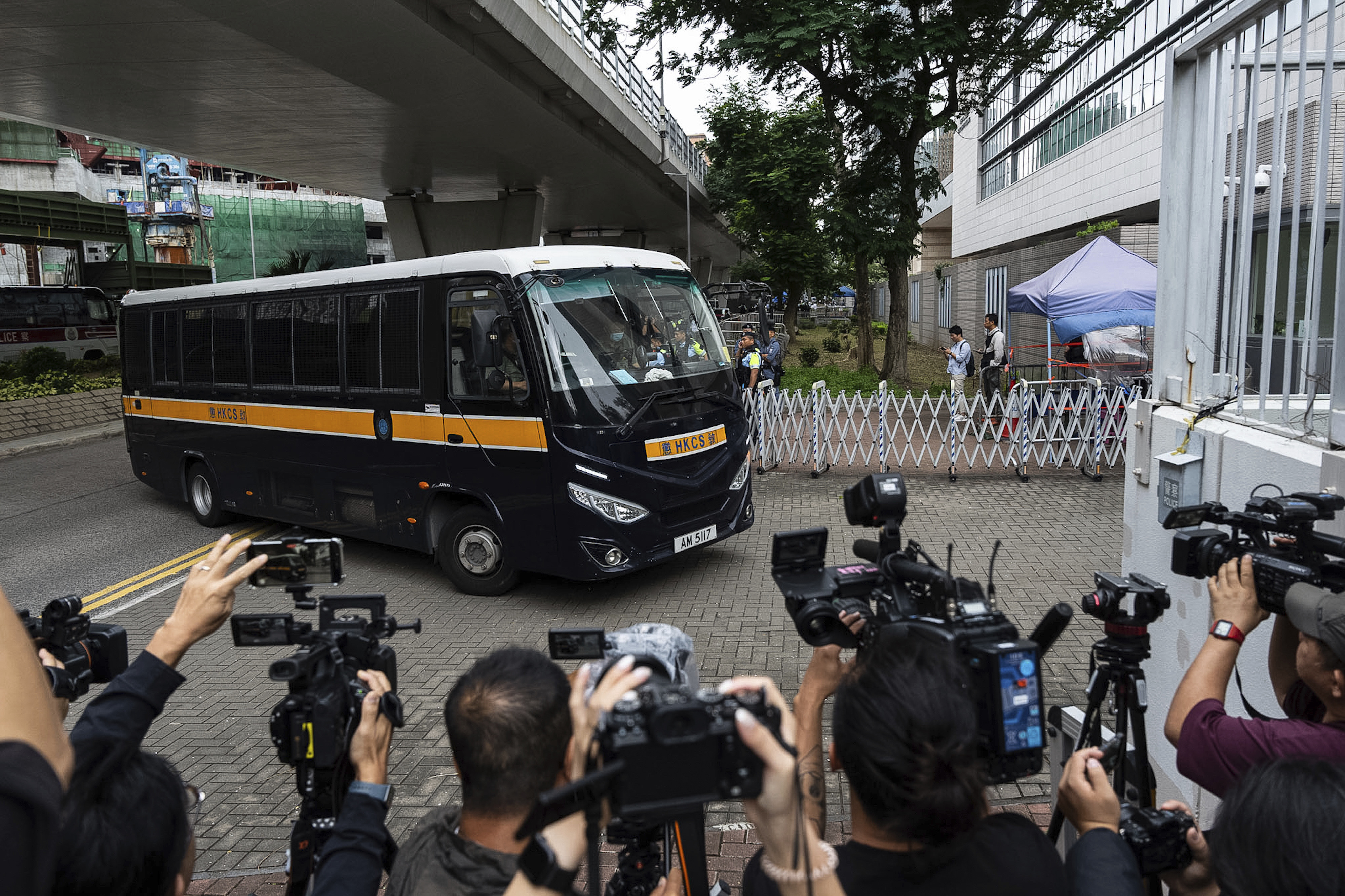 A prison minibus carrying some of the defendants denied bail arriving at the court for the hearing.