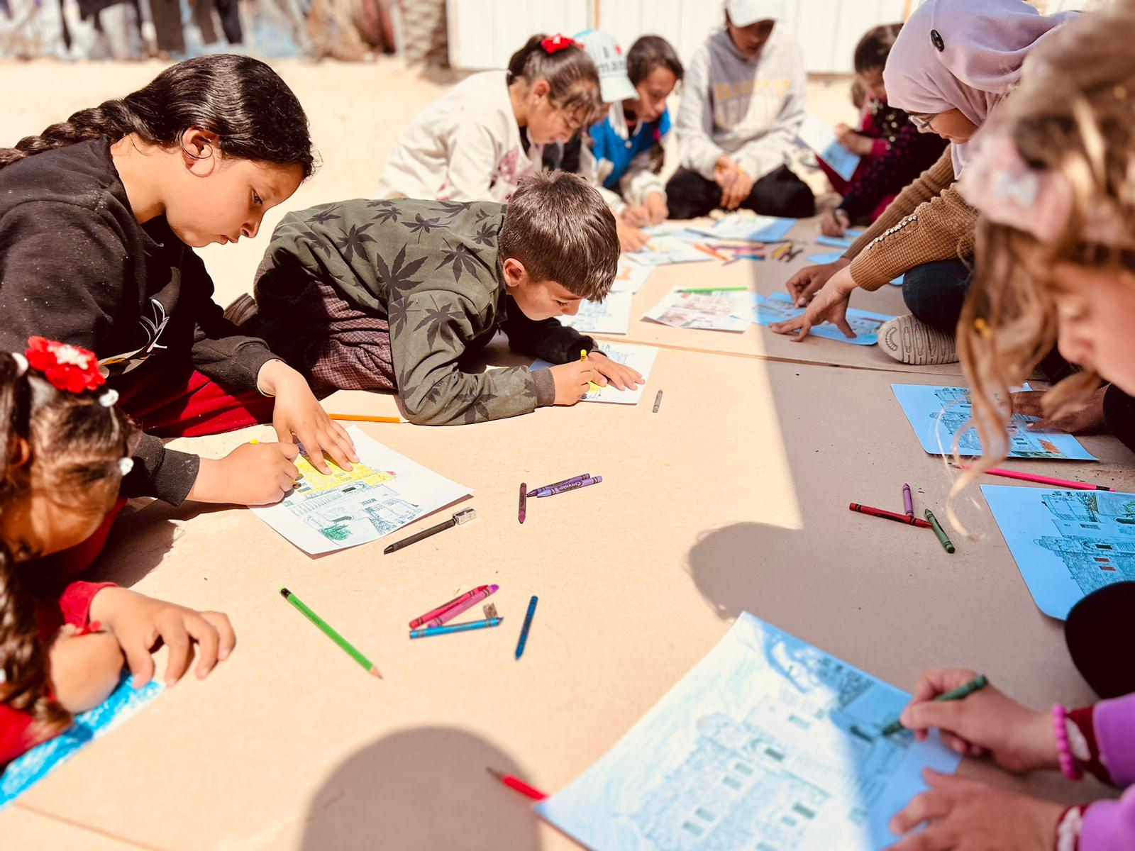 The weekly workshops give the children the opportunity to briefly put the conflict to the back of their mind and just be children again, like ten-year-old Rasem in the centre of the image and Zahra, aged 12, to his left (not their real names).