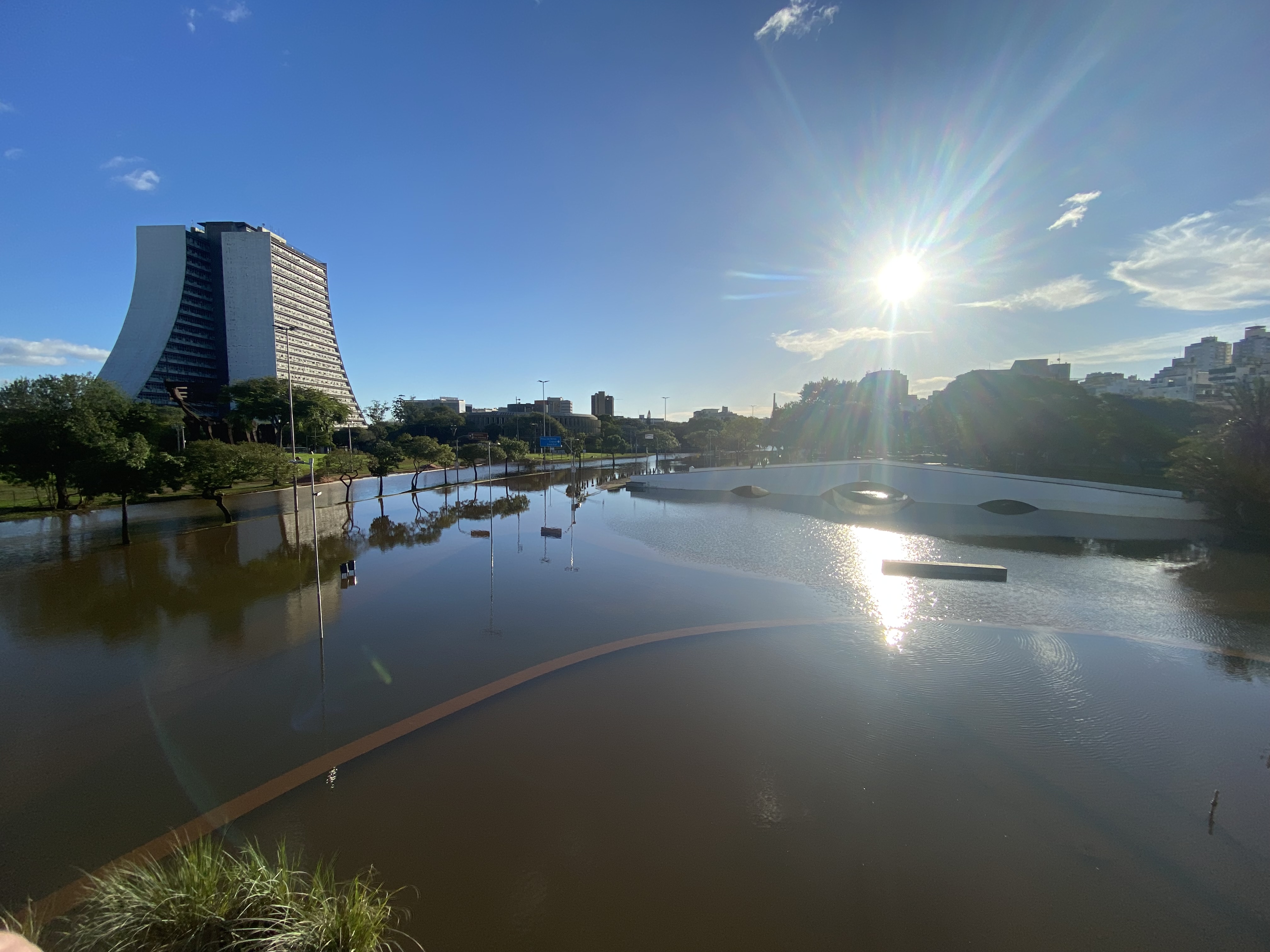 The sun shines over a flooded city landscape in Porto Alegre in Brazil.