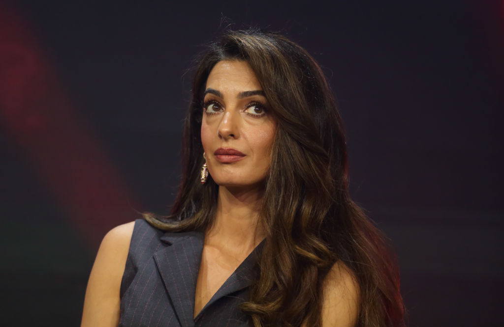 a woman with brown hair gives a side eye