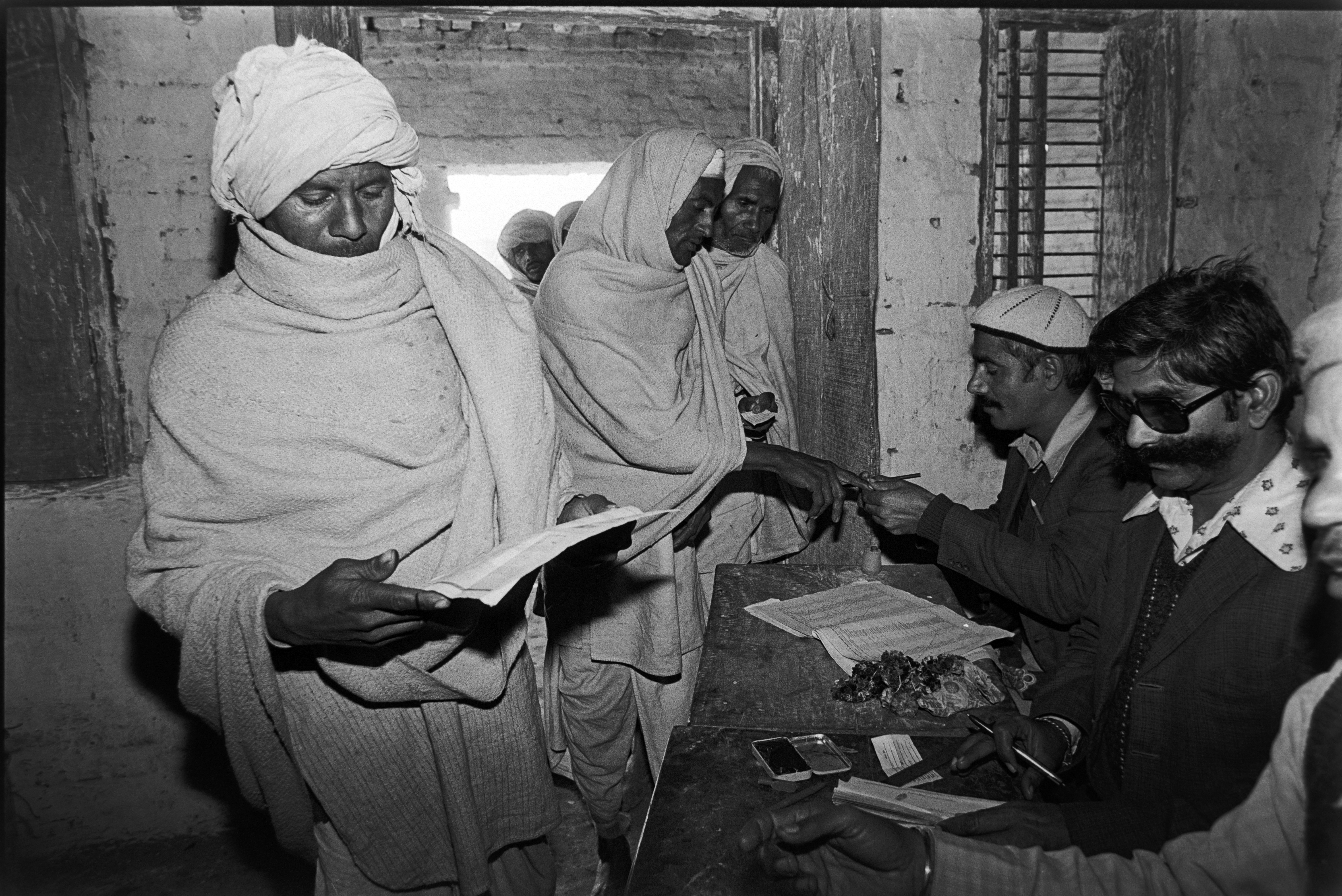 Villagers cast their vote at a polling center in the middle of sugar cane fields in the rural Baghpat district in Uttar Pradesh, India, on January 06, 1980.