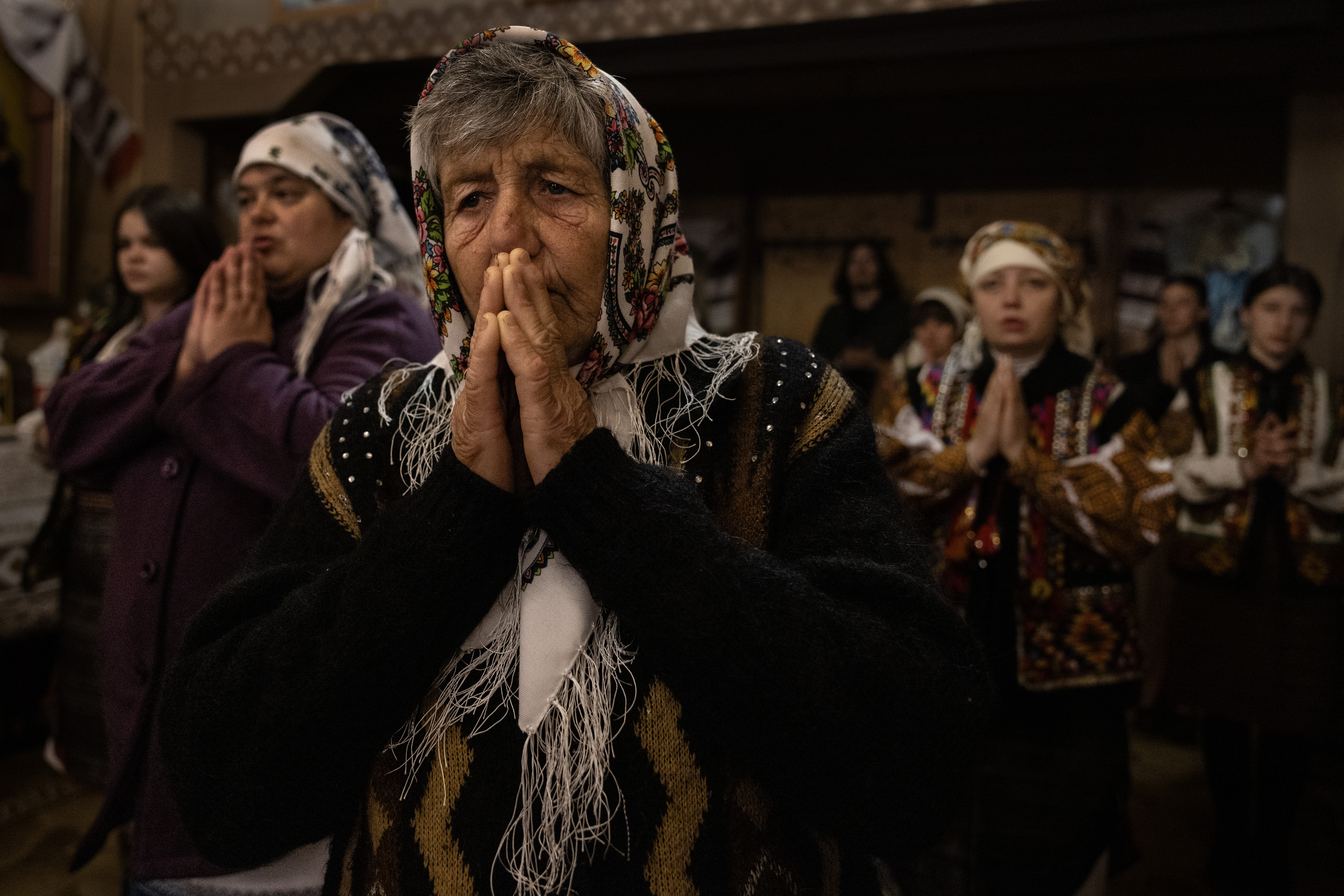Ukrainian women pray during overnight Easter service at the Church of the Nativity of the Theotokos in Kryvorivnia