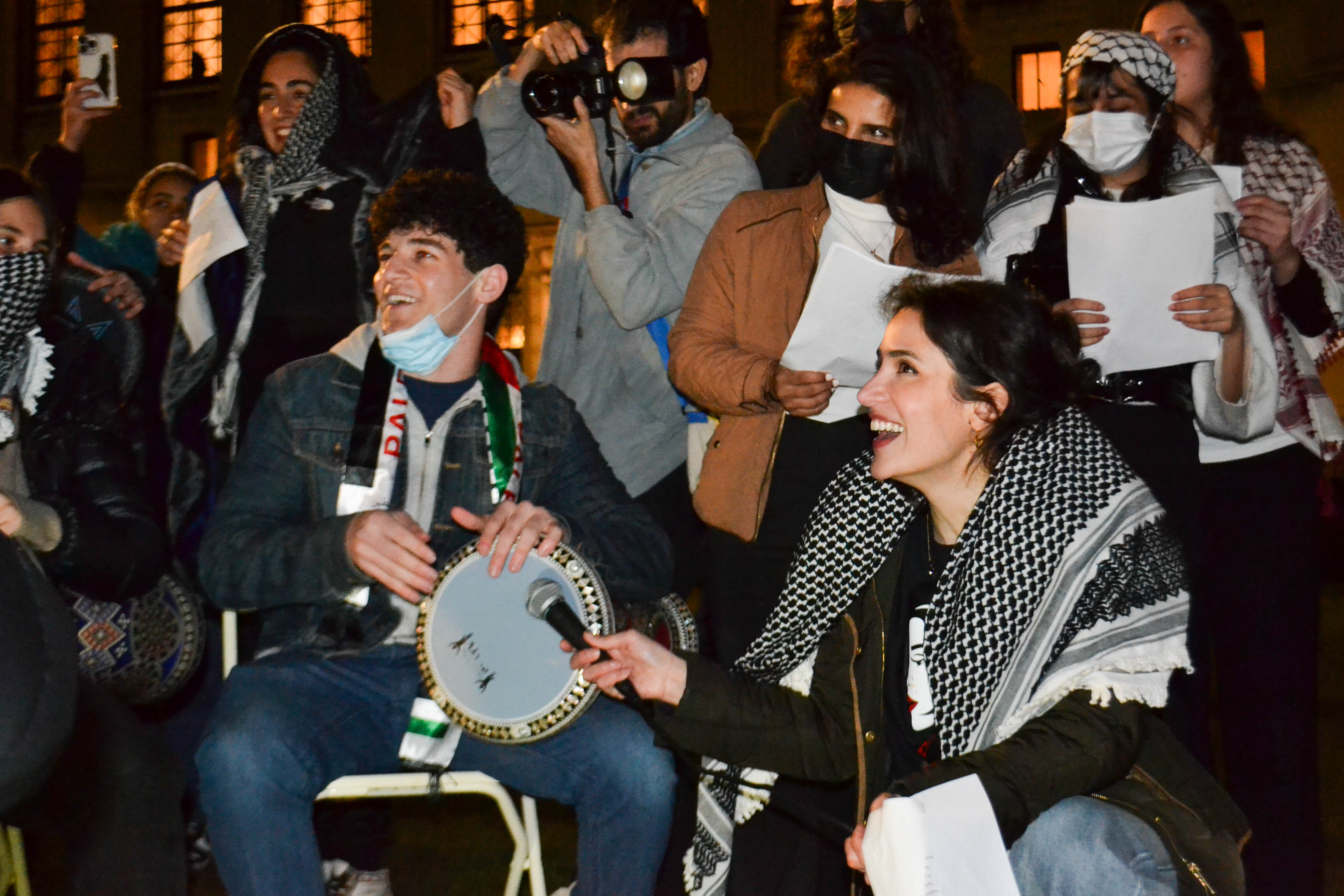 Student protesters playing music at the encampment in Columbia University in New York City [Yasmeen Altaji/Al Jazeera]