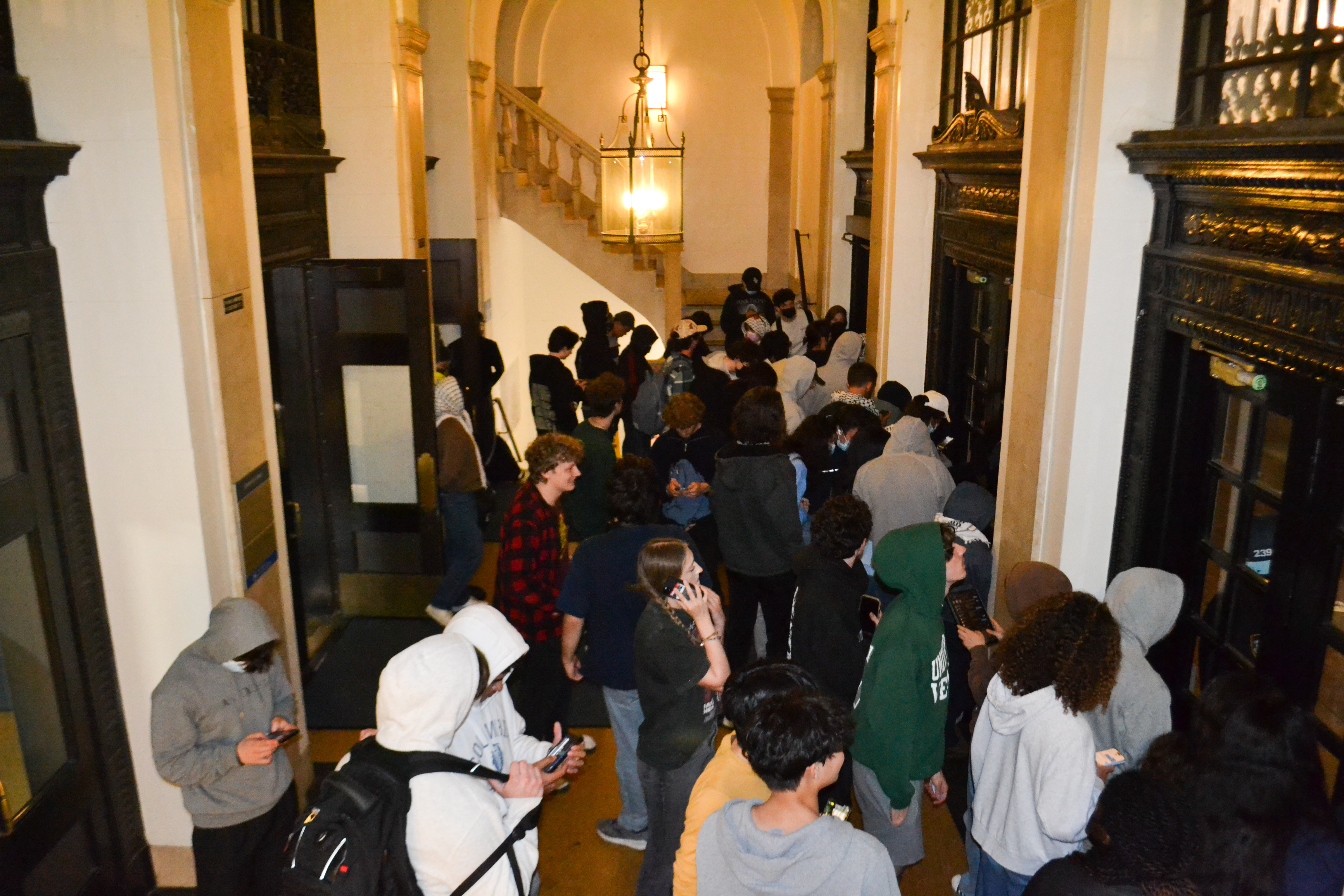 Students, including student journalists, trapped inside the entrance vestibule at John Jay Hall in Columbia University in N ew York on Tuesday, April 30, 2023 [Yasmeen Altaji/Al Jazeera]