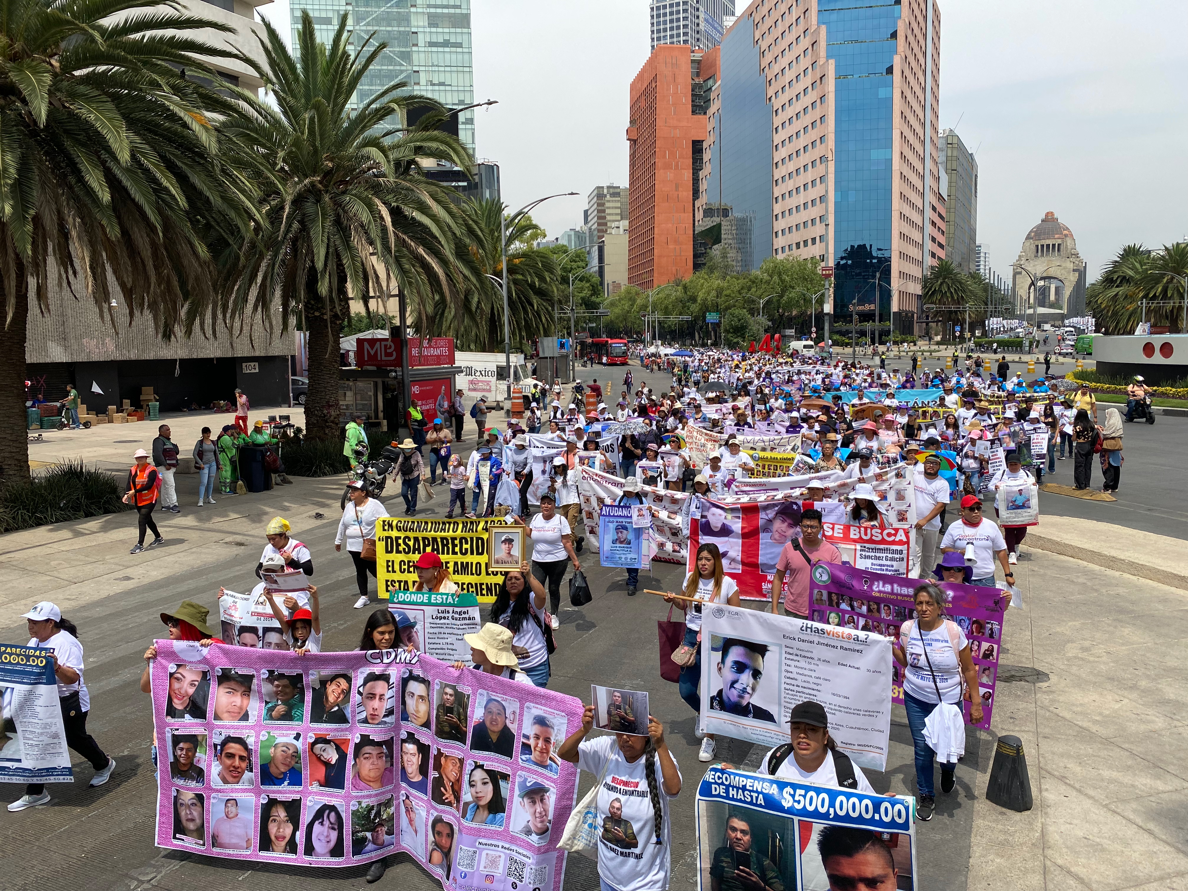 Families and activists march through the streets of Mexico City, carrying banners and posters with the faces of the missing.
