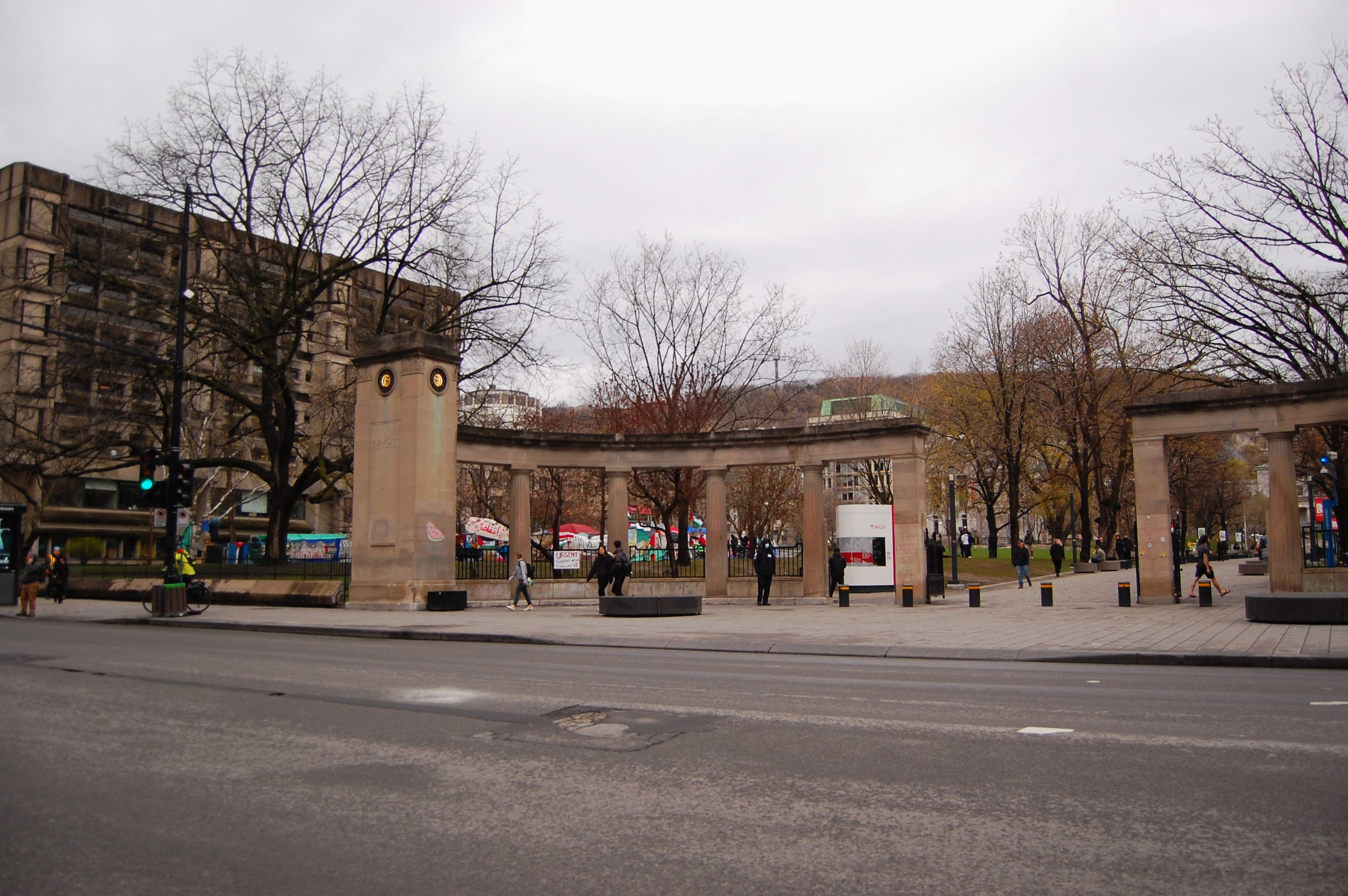 A view of the Gaza protest encampment through the main gate of McGill University