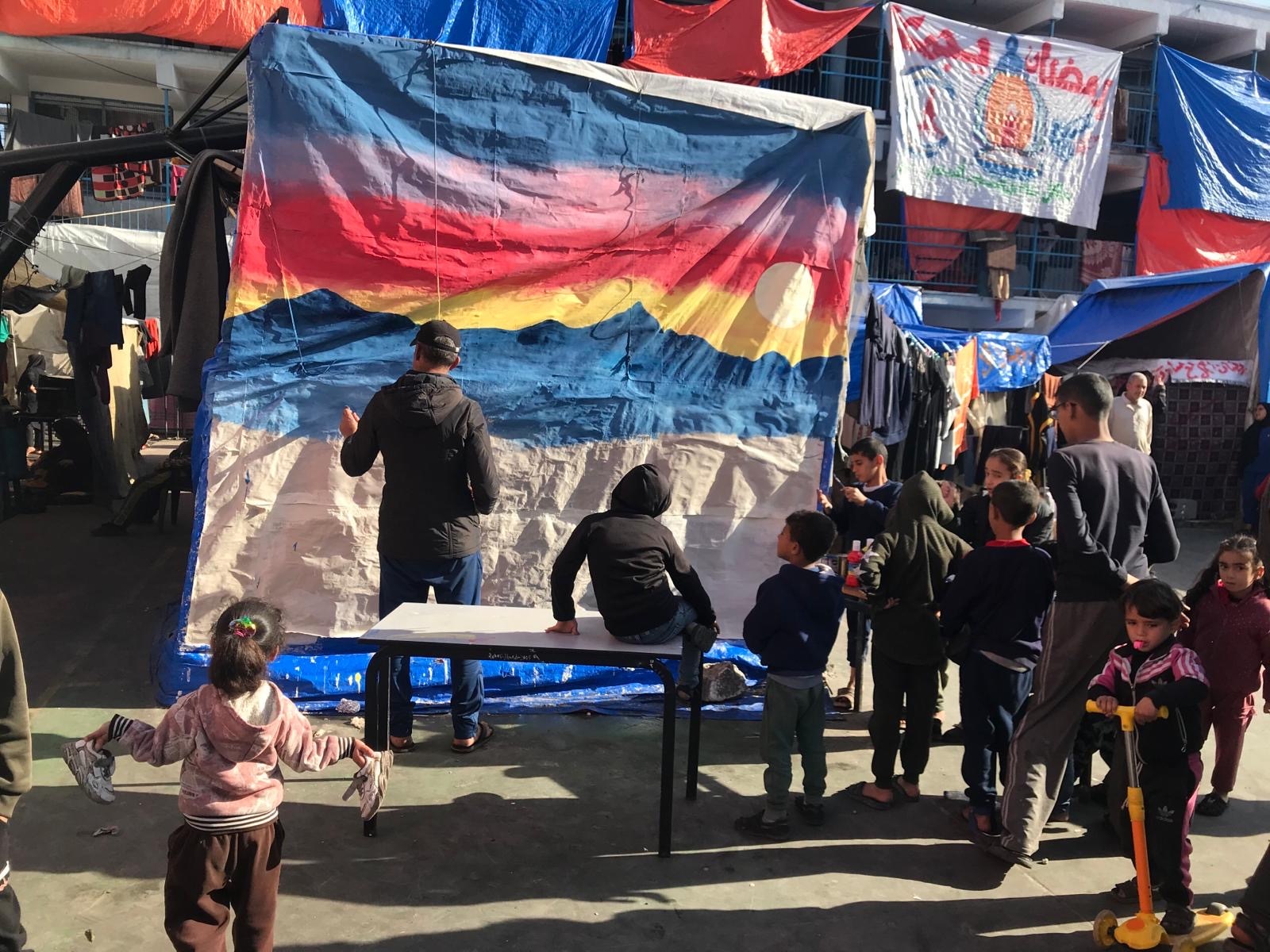 Mohammed Almadhoun leads painting workshops with children at the school he is sheltering in