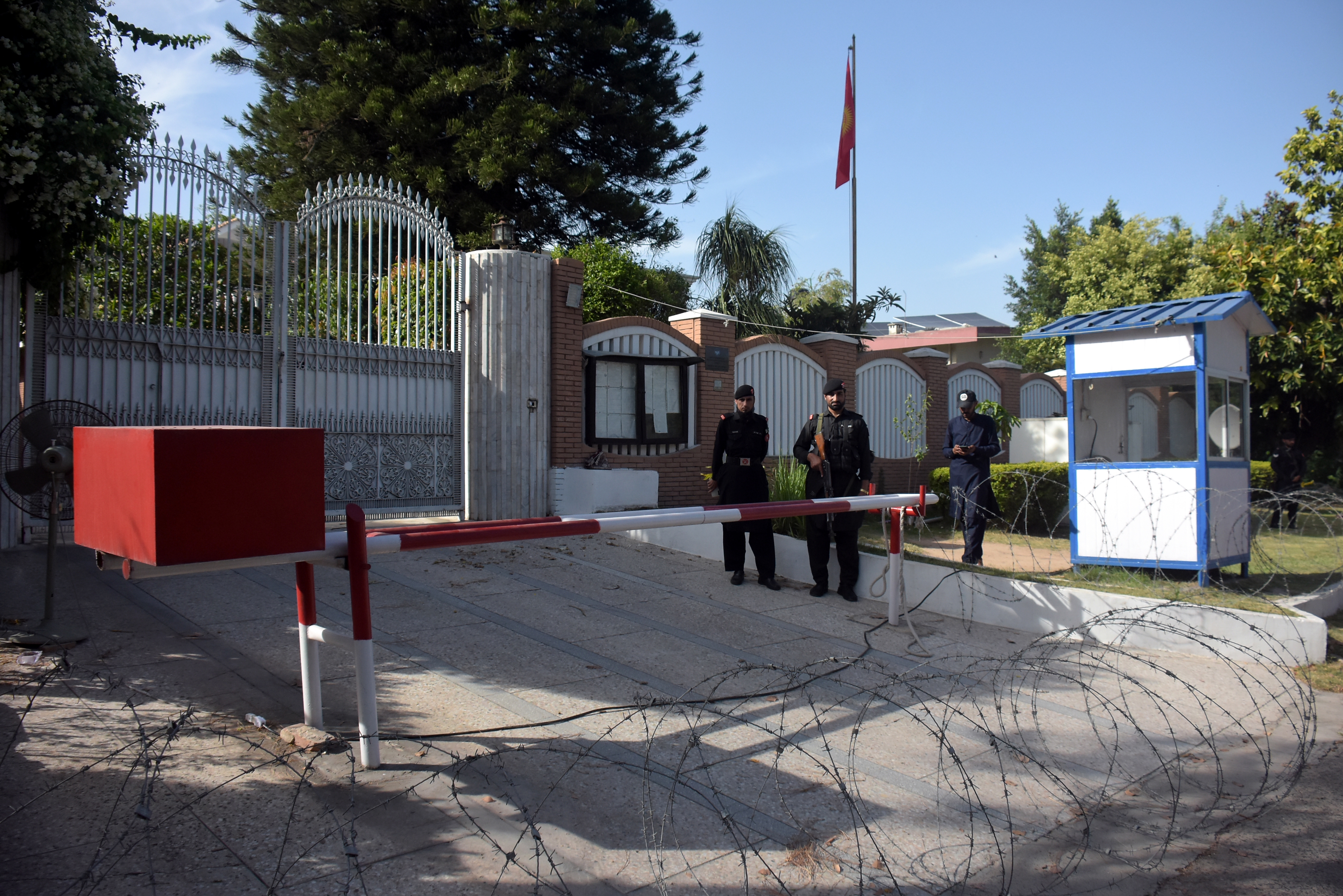 Security officials stand guard outside the Kyrgyz embassy in Islamabad after protests against violence in Bishkek targeting international students