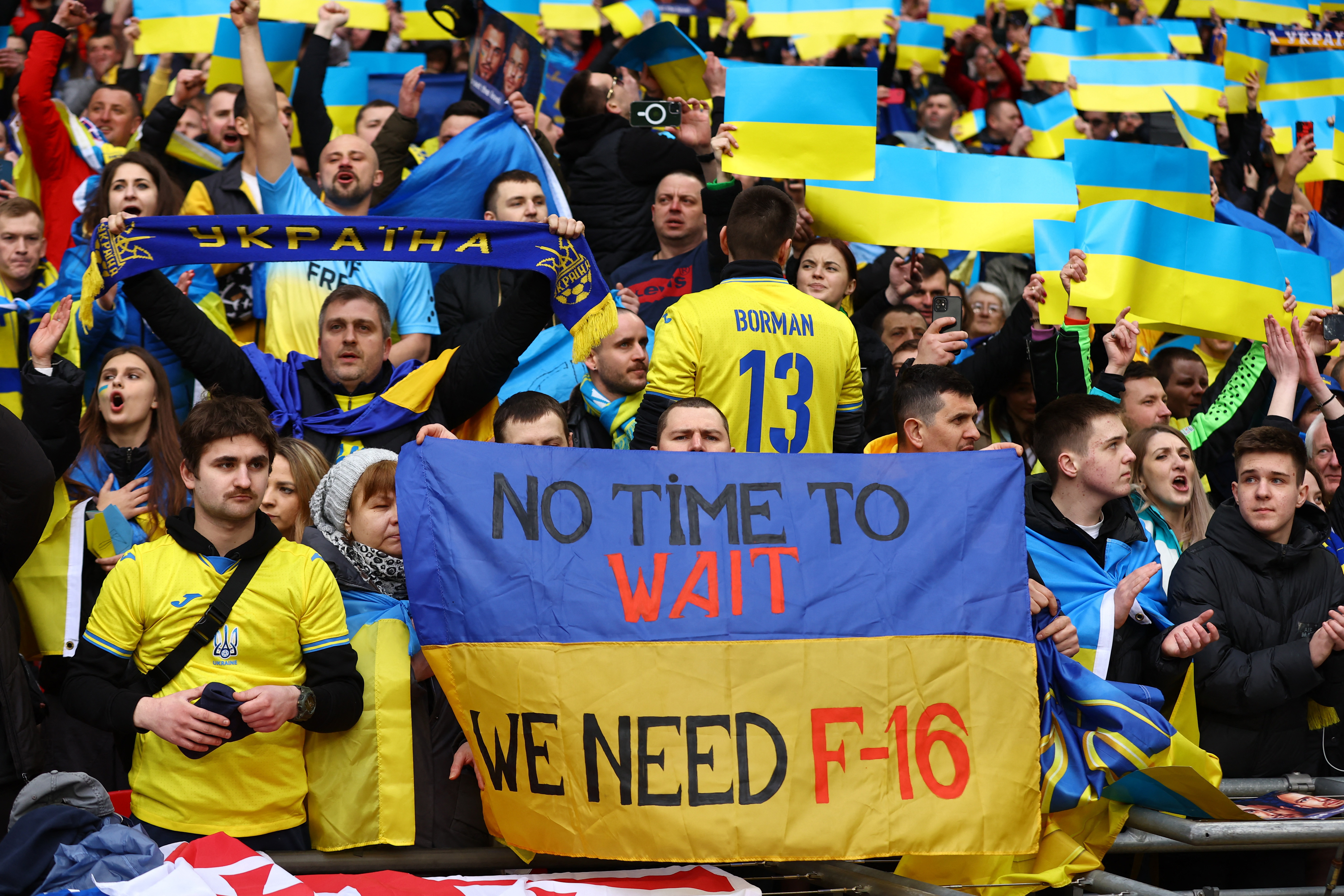 Soccer Football - UEFA Euro 2024 Qualifiers - Group C - England v Ukraine - Wembley Stadium, London, Britain - March 26, 2023 Ukraine fan with a banner with a message saying 'We need F-16' inside the stadium before the match Action Images via Reuters/Matthew Childs