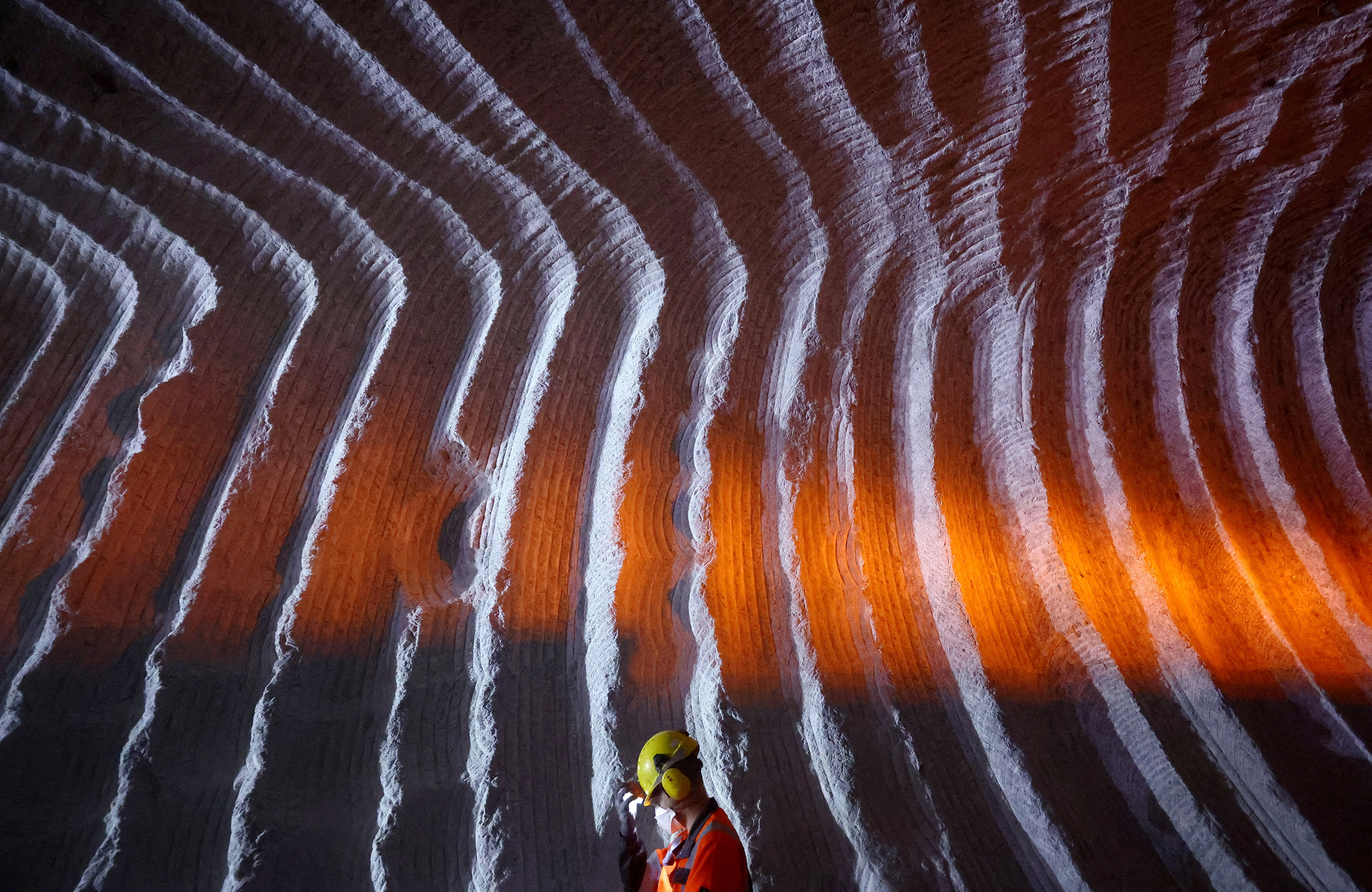 A miner in Heilbronn is seen inside a salt mine where construction is under way to build the long SuedLink electric power line to transport green energy from wind turbines from the northern coast to Germany's south from 2028