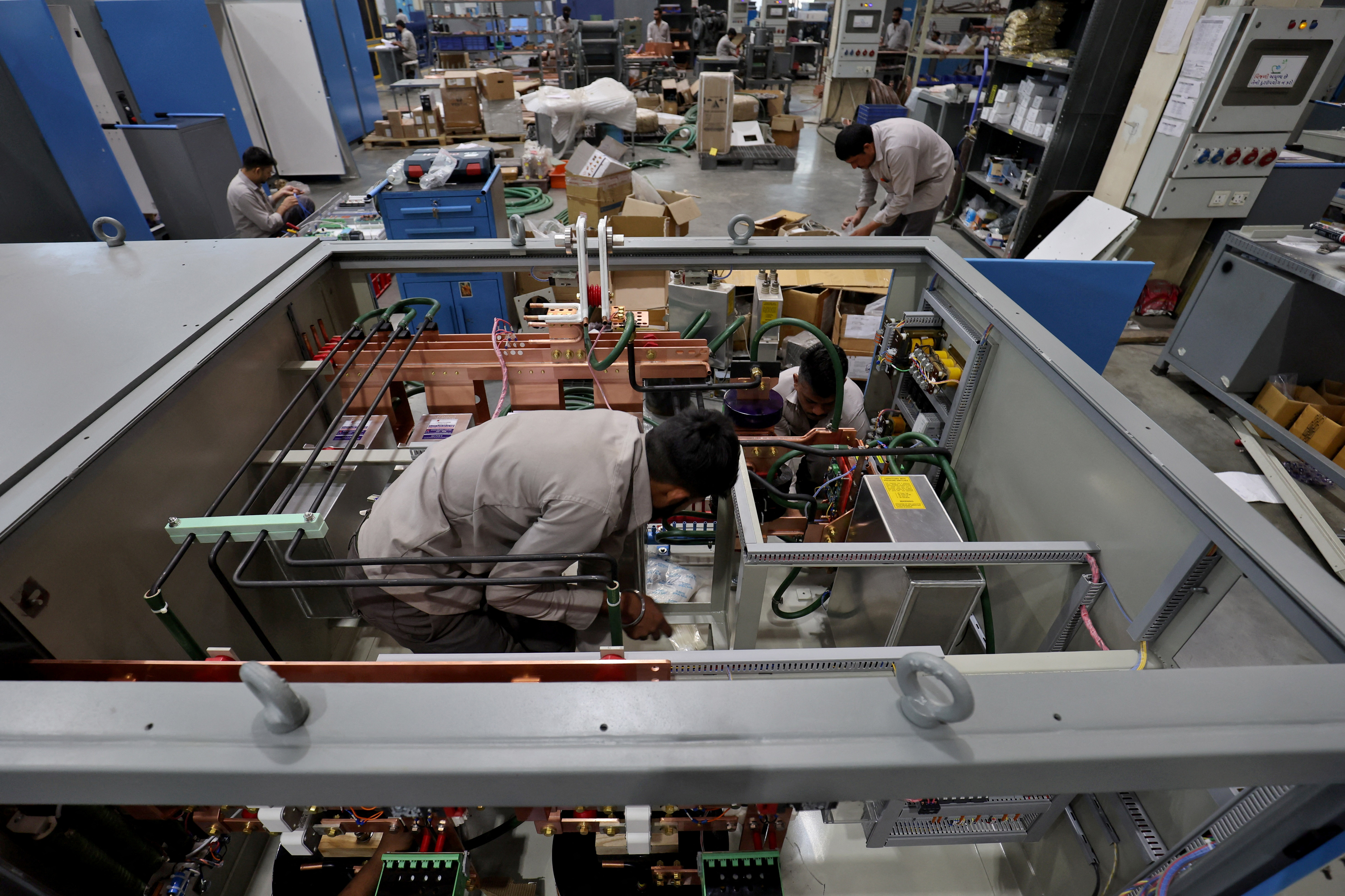 Employees assemble an electric transformer inside a manufacturing unit of Inductotherm (India) Private Limited at Sanand GIDC (Gujarat Industrial Development Corporation), on the outskirts of Ahmedabad, India