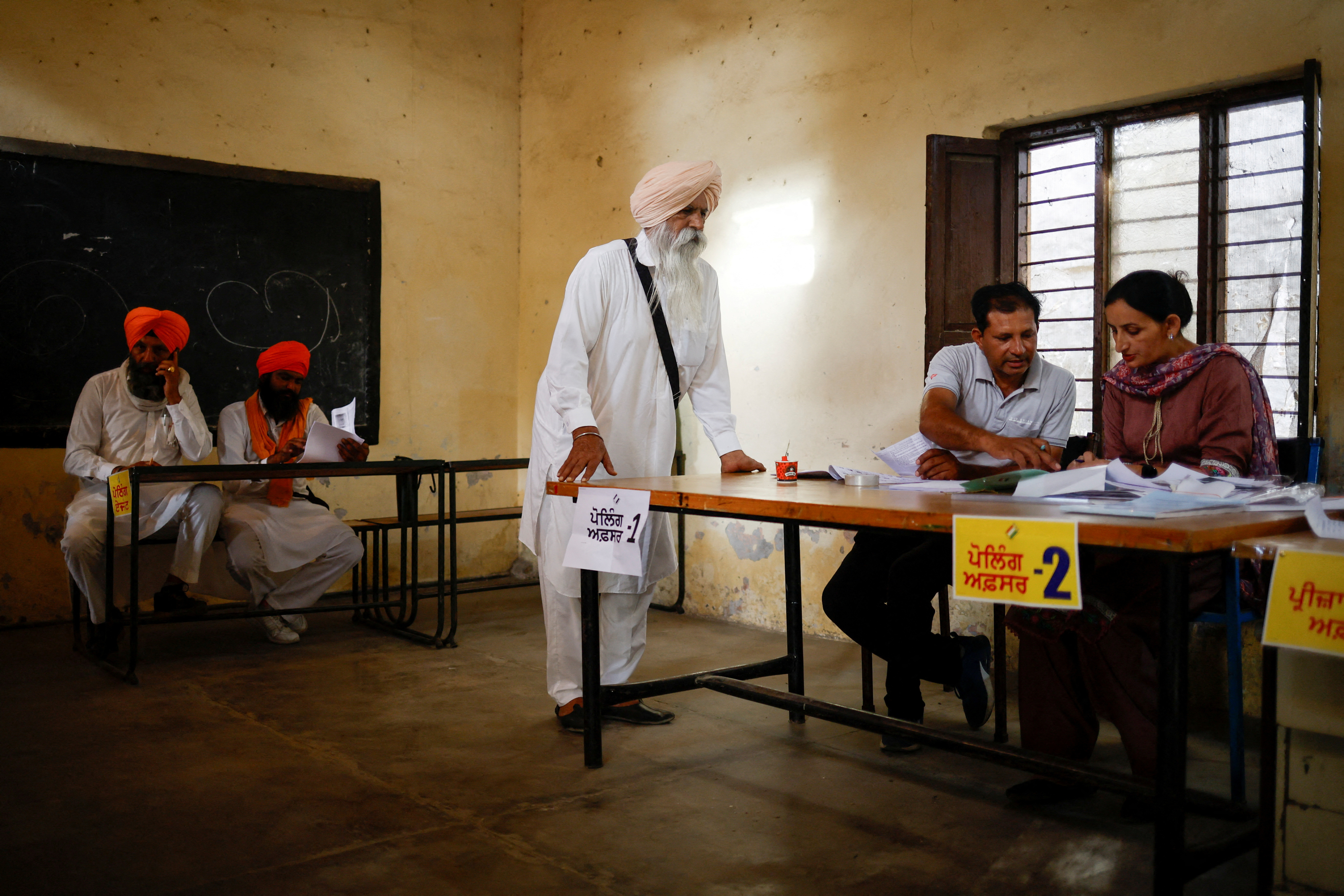 A man waits to vote at a polling station during the seventh and last phase of the general election, at a town in Firozpur district, Punjab, India, June 1