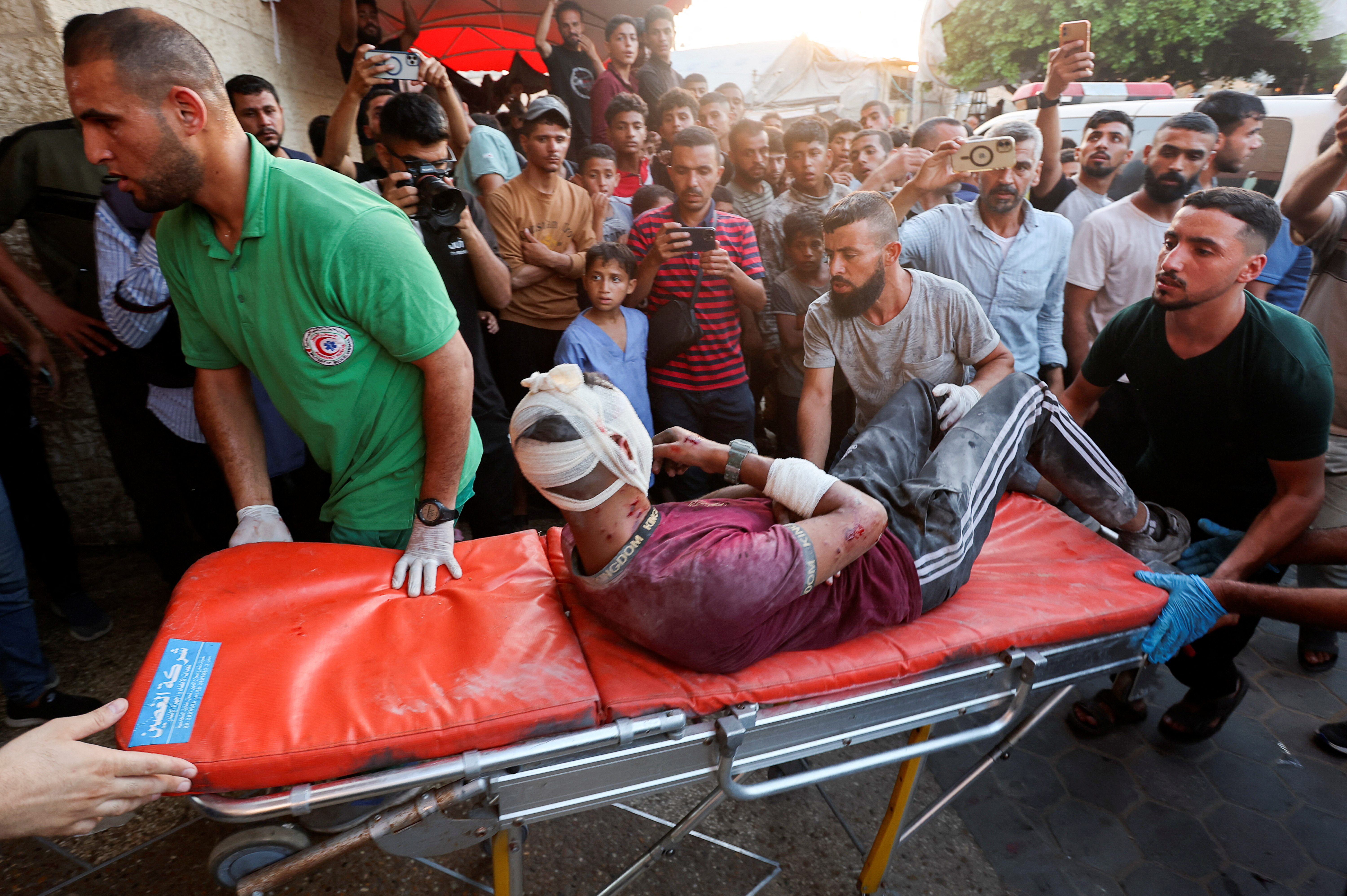 Medical workers tend to a Palestinian, who was wounded in an Israeli strike