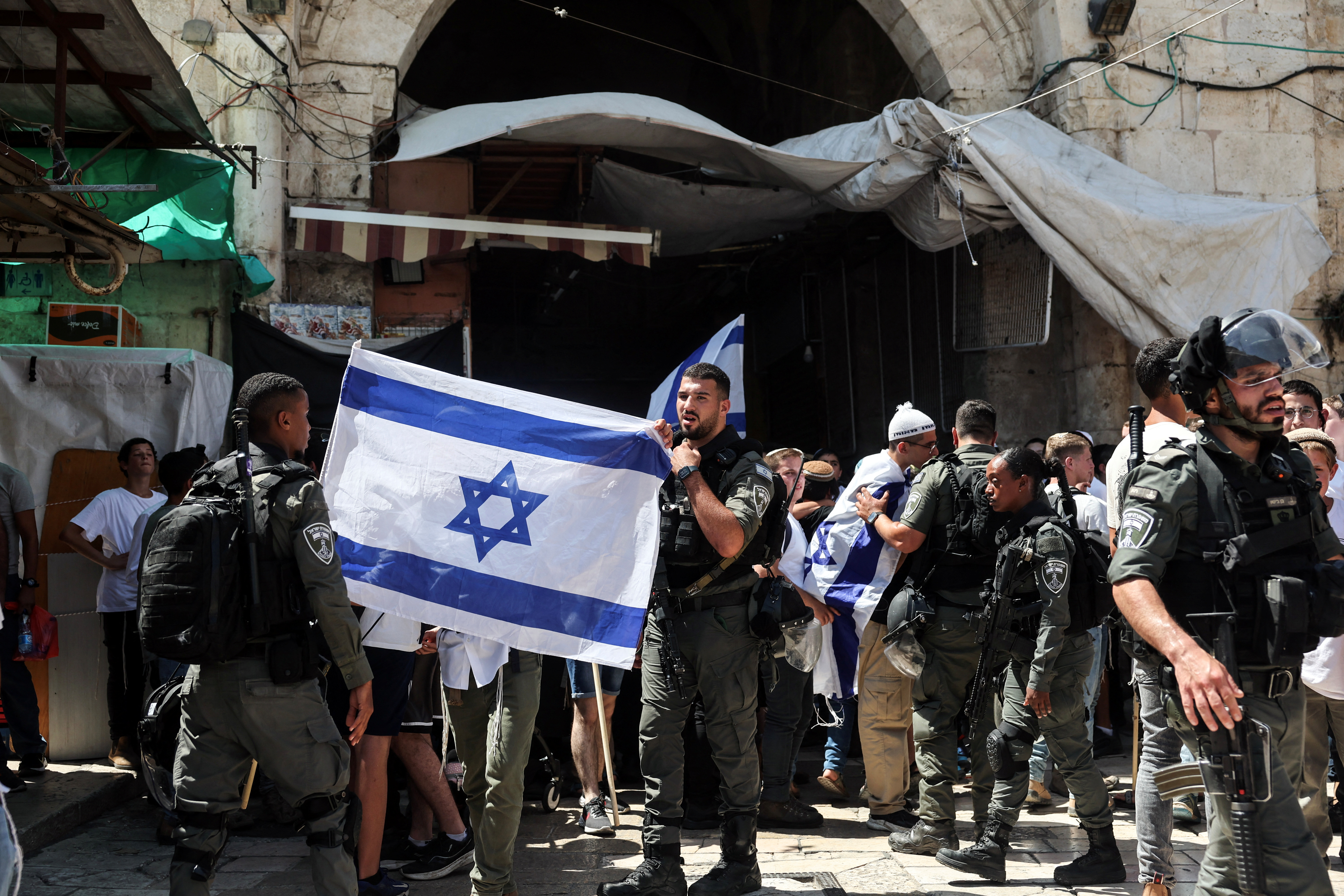 Israelis march through the alleyways of Jerusalem's Old City to the Western Wall, waving Israeli flags on 'Jerusalem Day' to commemorate the establishment of Israeli control over the city.