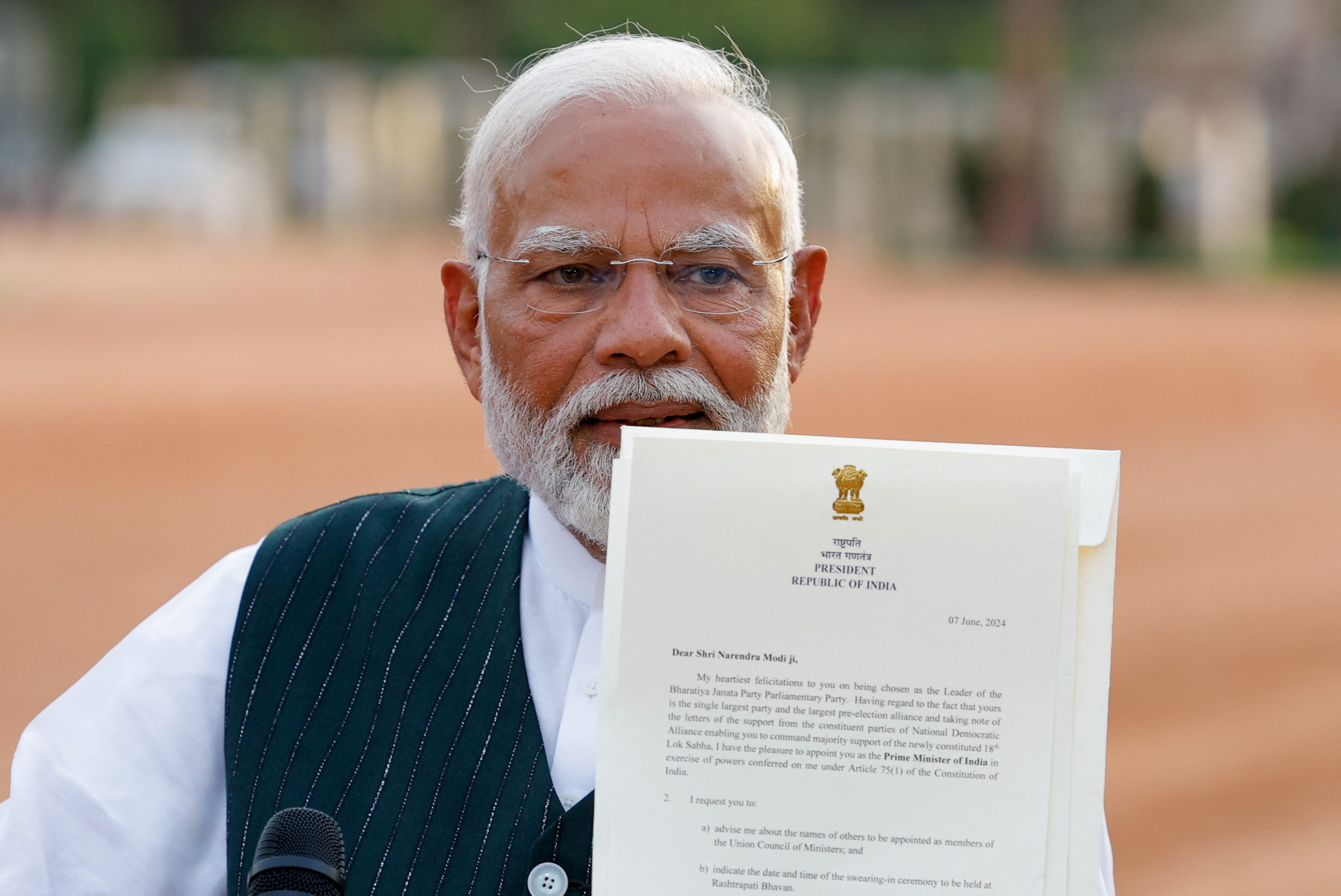 India's Prime Minister Narendra Modi shows the media a letter that he received from India's President Droupadi Murmu inviting him to form a new government after meeting her at the Presidential Palace in New Delhi, India, June 7, 2024. REUTERS/Adnan Abidi (Reuters)