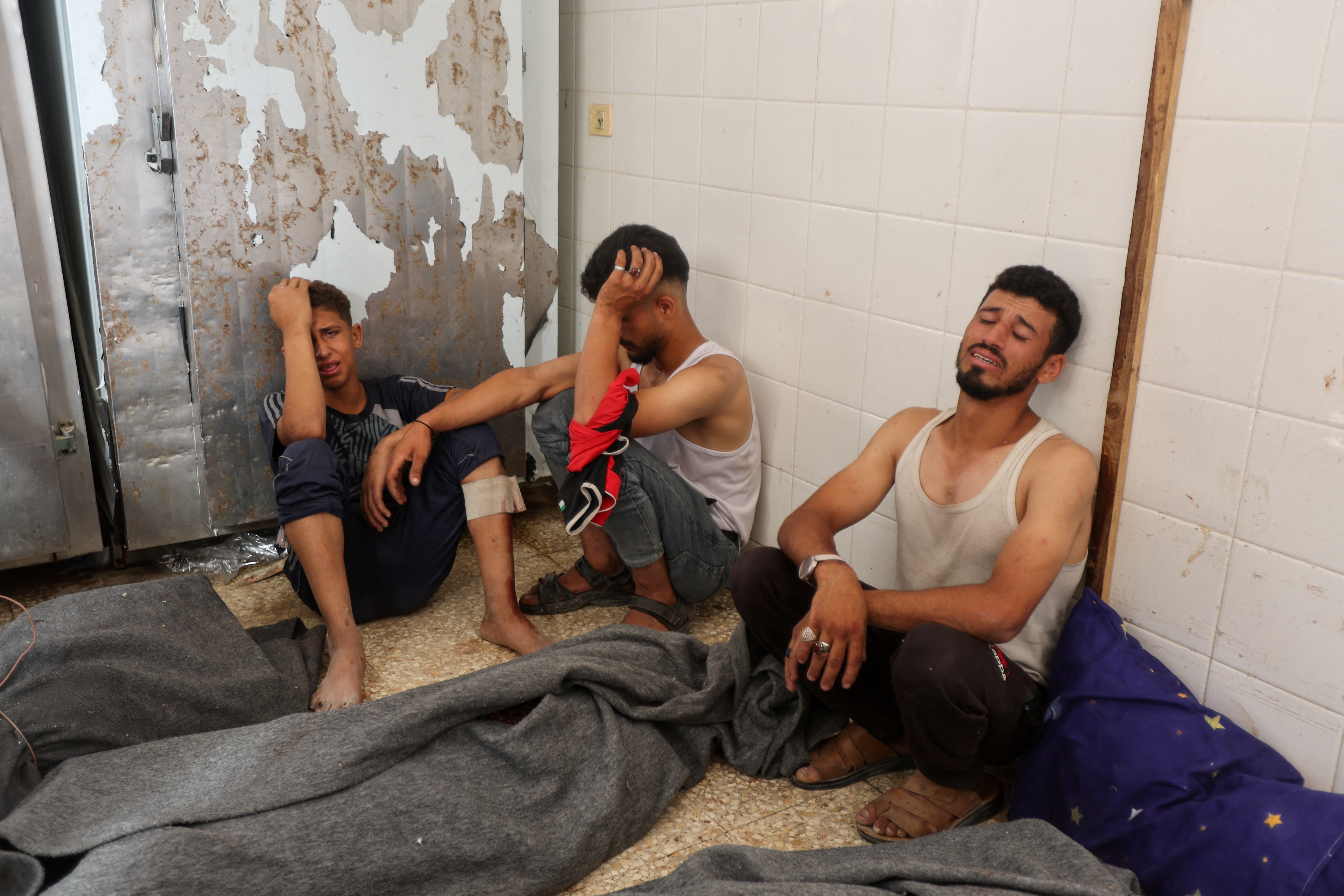 Mourners react during the funeral of Palestinians killed in Israeli strikes, amid the Israel-Hamas conflict, in Deir Al-Balah, in central Gaza Strip June 8