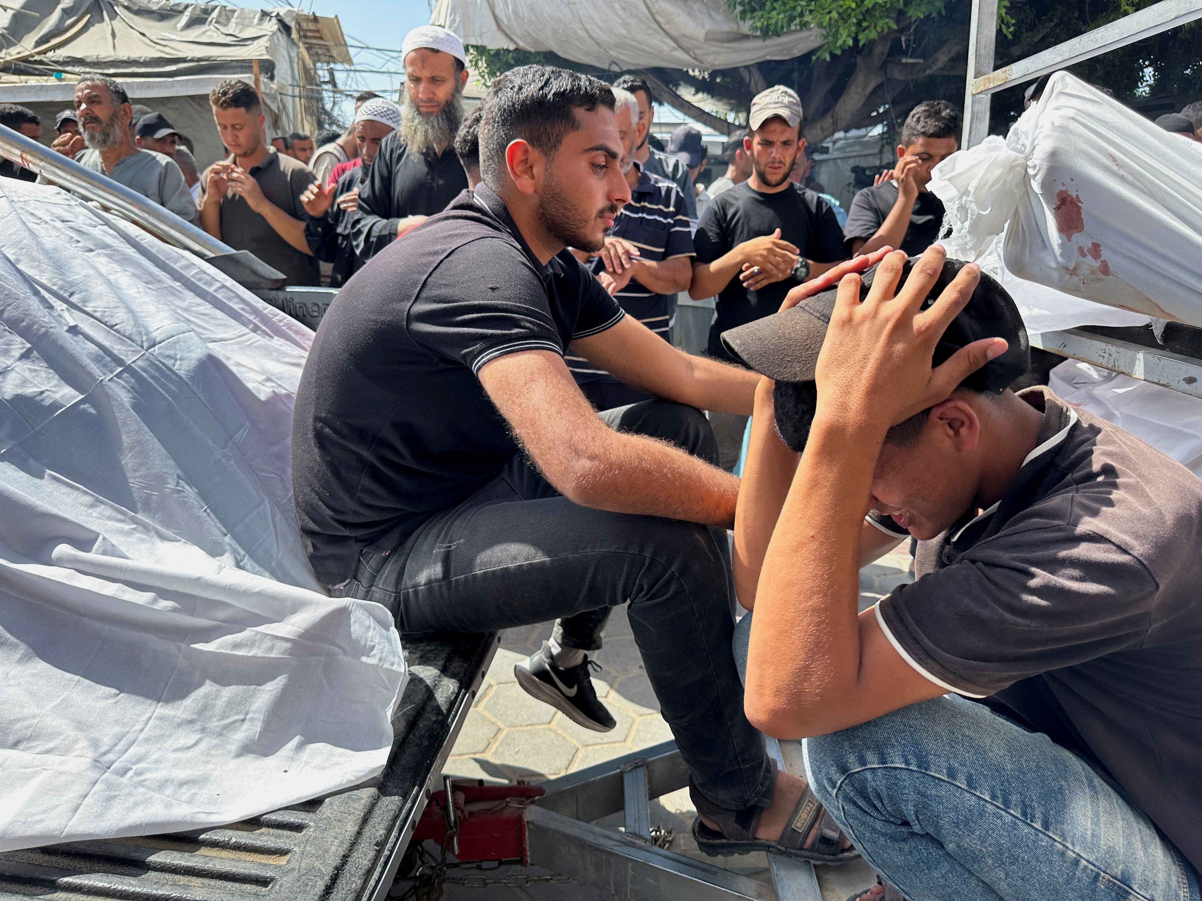 Mourners react during the funeral of Palestinians killed in Israeli strikes, amid the Israel-Hamas conflict, in Deir Al-Balah, in central Gaza Strip June 8