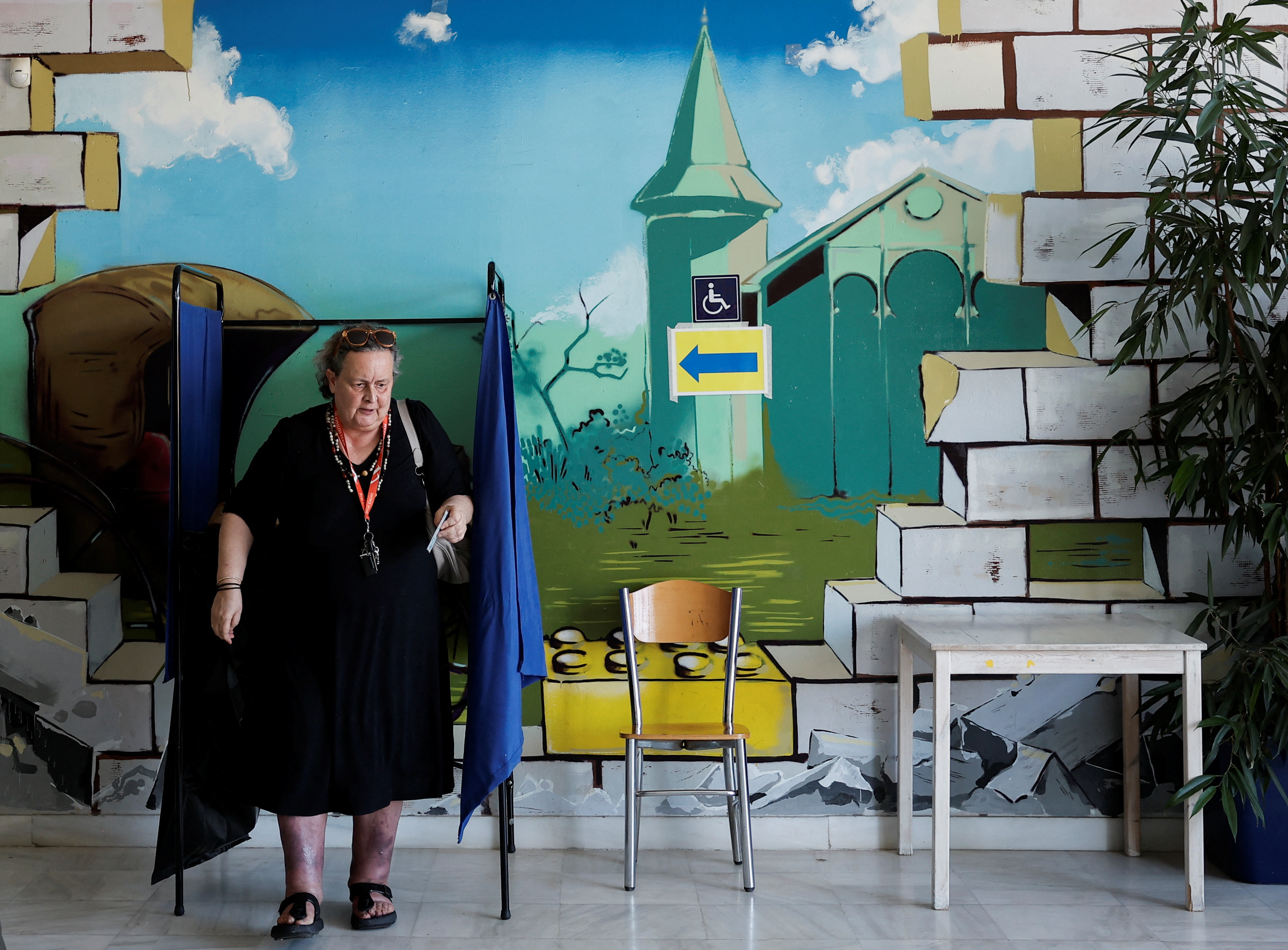 A woman votes at a polling station, during the European Union's parliamentary elections, in Athens, Greece, June 9, 2024. REUTERS/Louiza Vradi