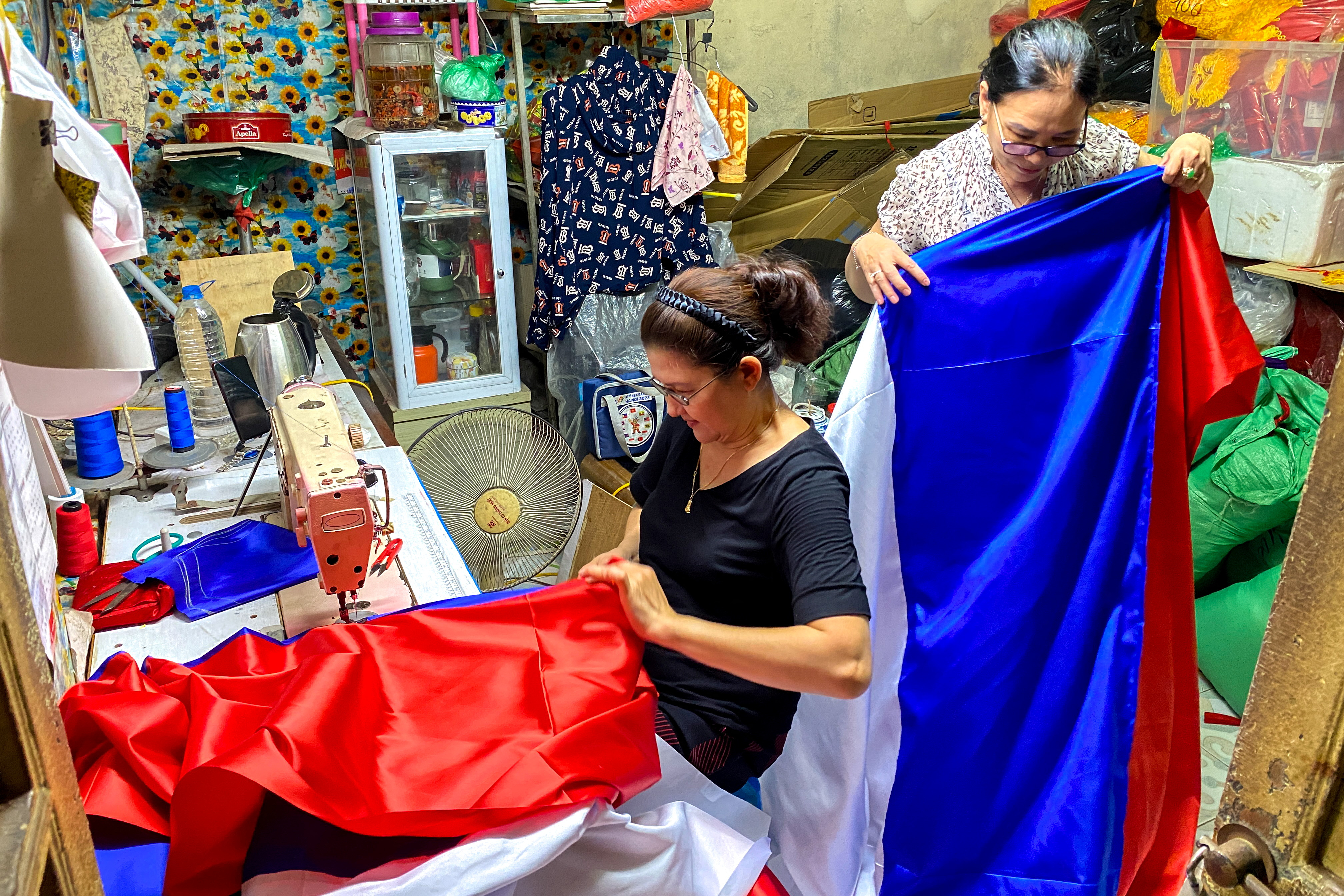 Le Kim Phuong, 60, and Le Thu Hong, 62 prepare Russian national flags ahead of Russian President Vladimir Putin's visit to Vietnam, in Hanoi, Vietnam, June 18, 2024. REUTERS/Thinh Nguyen