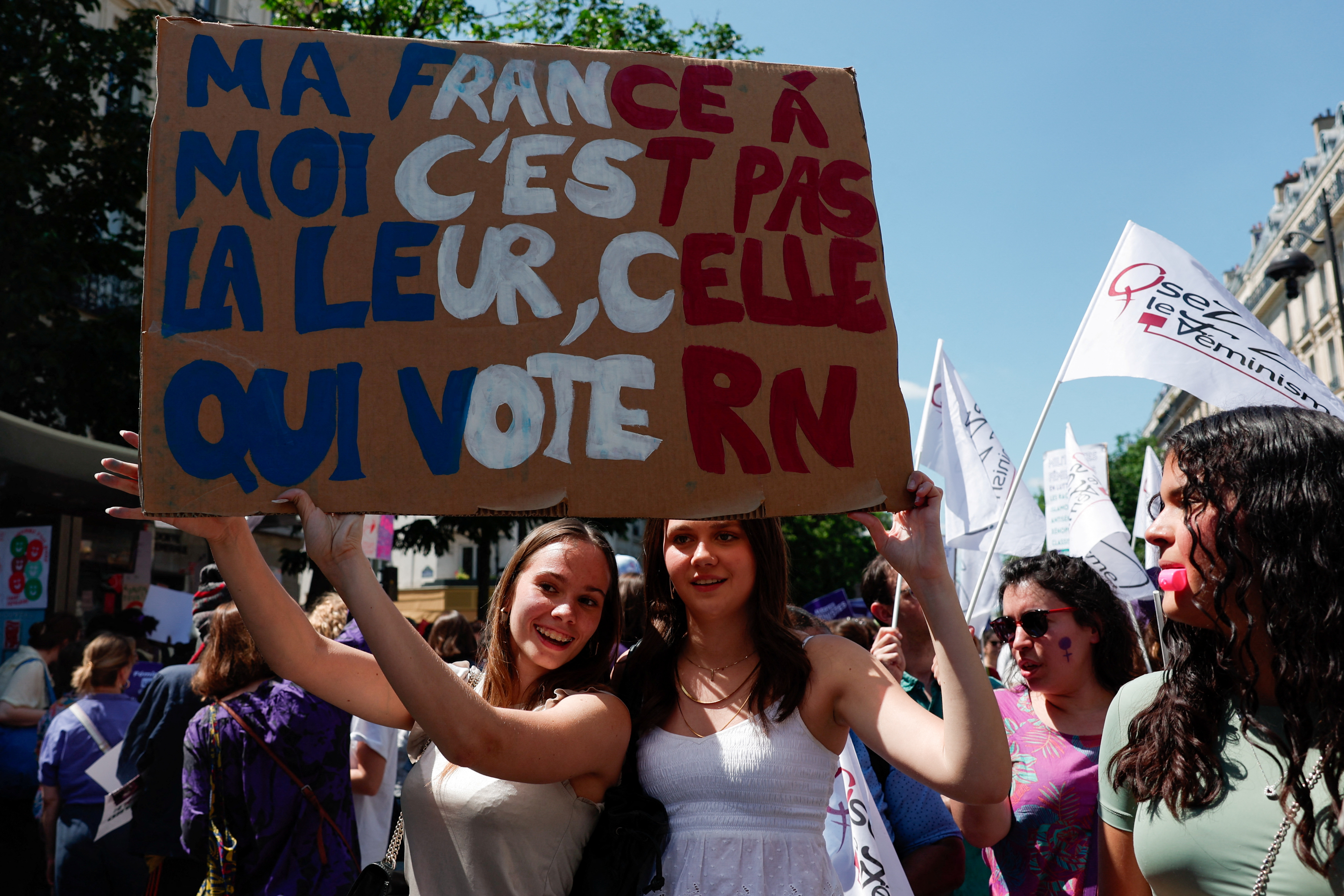 Women hold a placard that reads: "My France to me is not the same as (the France) of those who vote for RN", as people attend a demonstration organised by feminist organisations to protest against the French far-right National Rally (Rassemblement National - RN) party, ahead of upcoming French parliamentary elections, in Paris, France, June 23, 2024. REUTERS/Gonzalo Fuentes