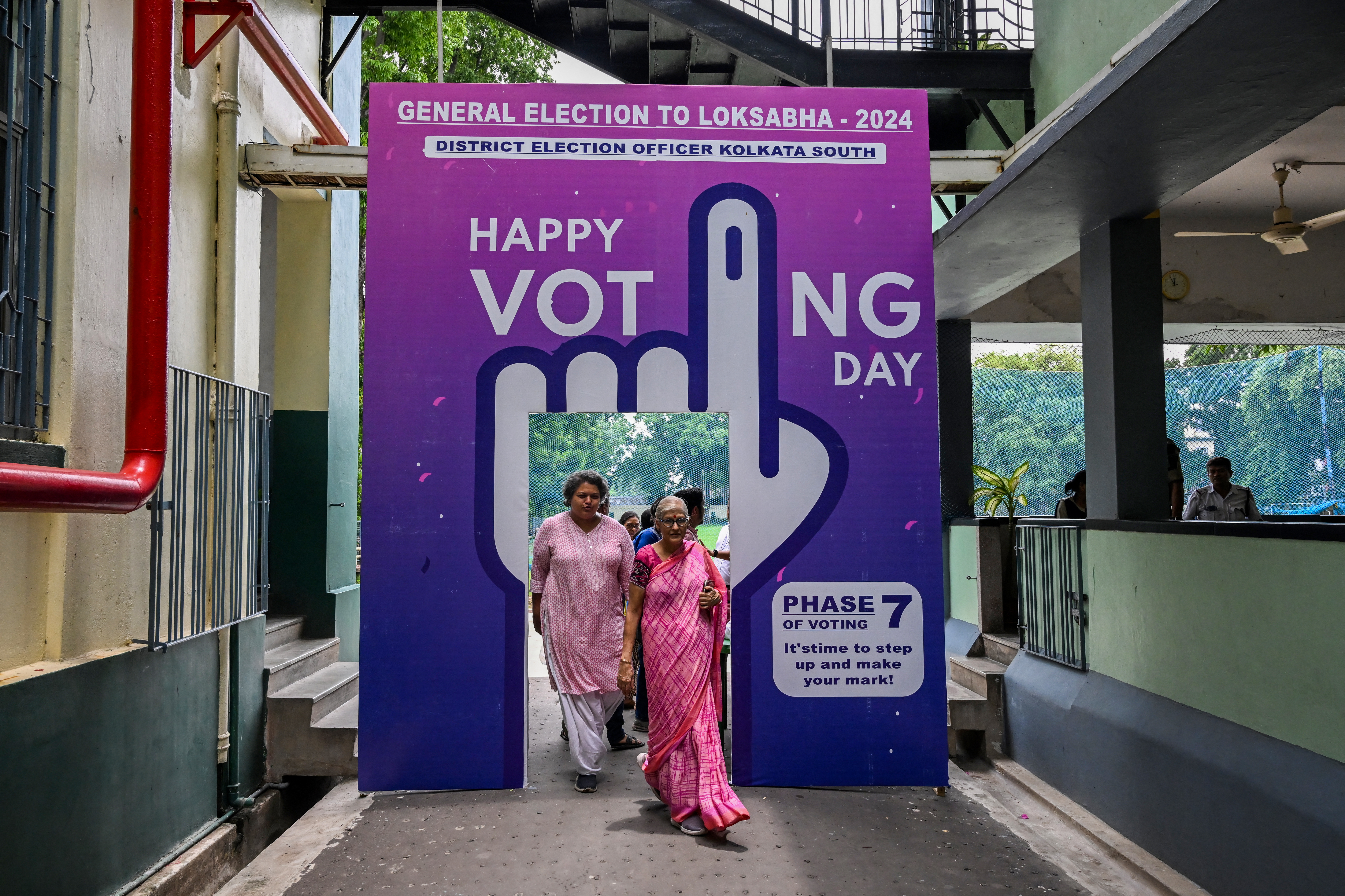 their ballot at a polling station on the seventh and final phase of voting in India's general election, in Kolkata on June 1