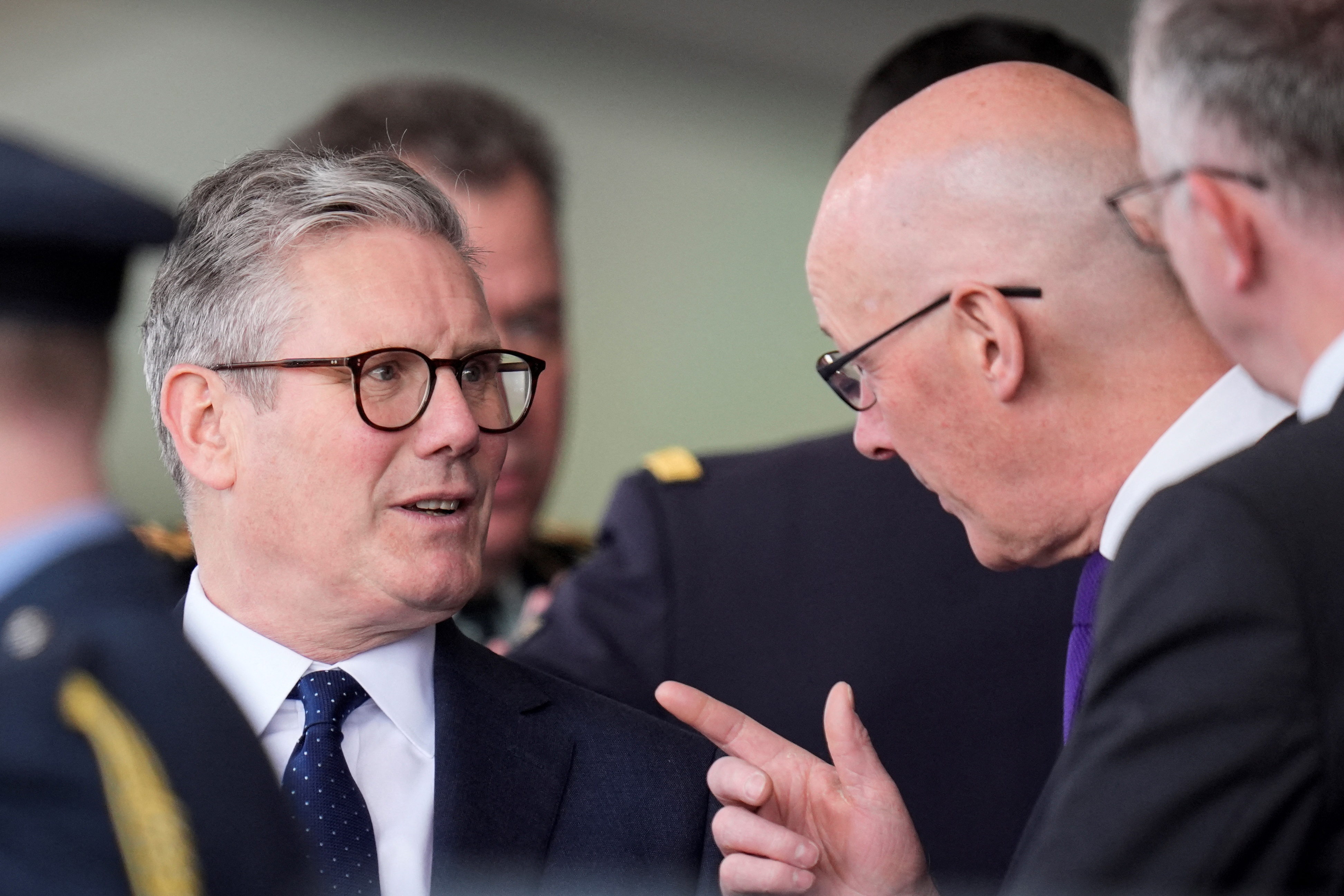 Britain's main opposition Labour Party leader Keir Starmer (L) speaks with Scotland's First Minister John Swinney (R) as they attend a UK national commemorative event to mark the 80th anniversary commemorations