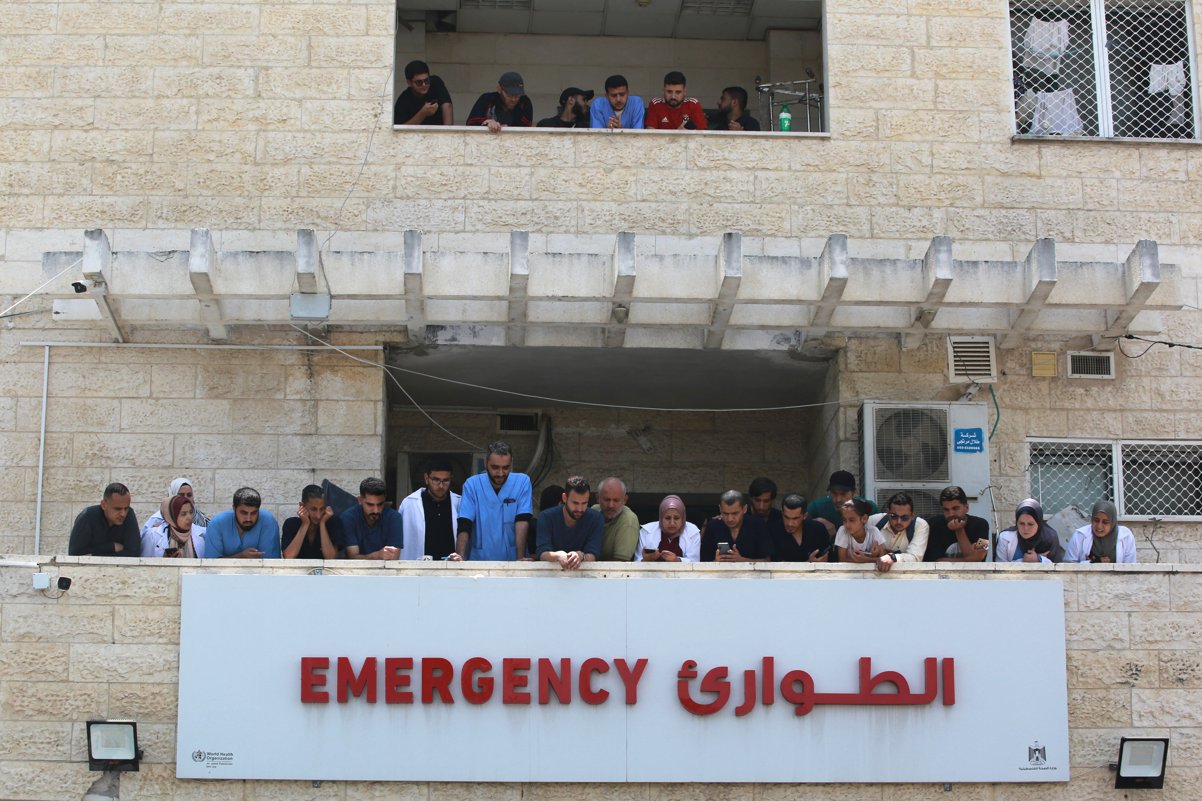 Medics and nurses wait and watch for the arrival of injured and killed Palestinian to the al-Aqsa Martyrs Hospital in Deir al-Balah, in the central Gaza Strip, following the Israeli bombardment of a residential apartment in Deir al-Balah and an area of al-Maghazi, on June 8