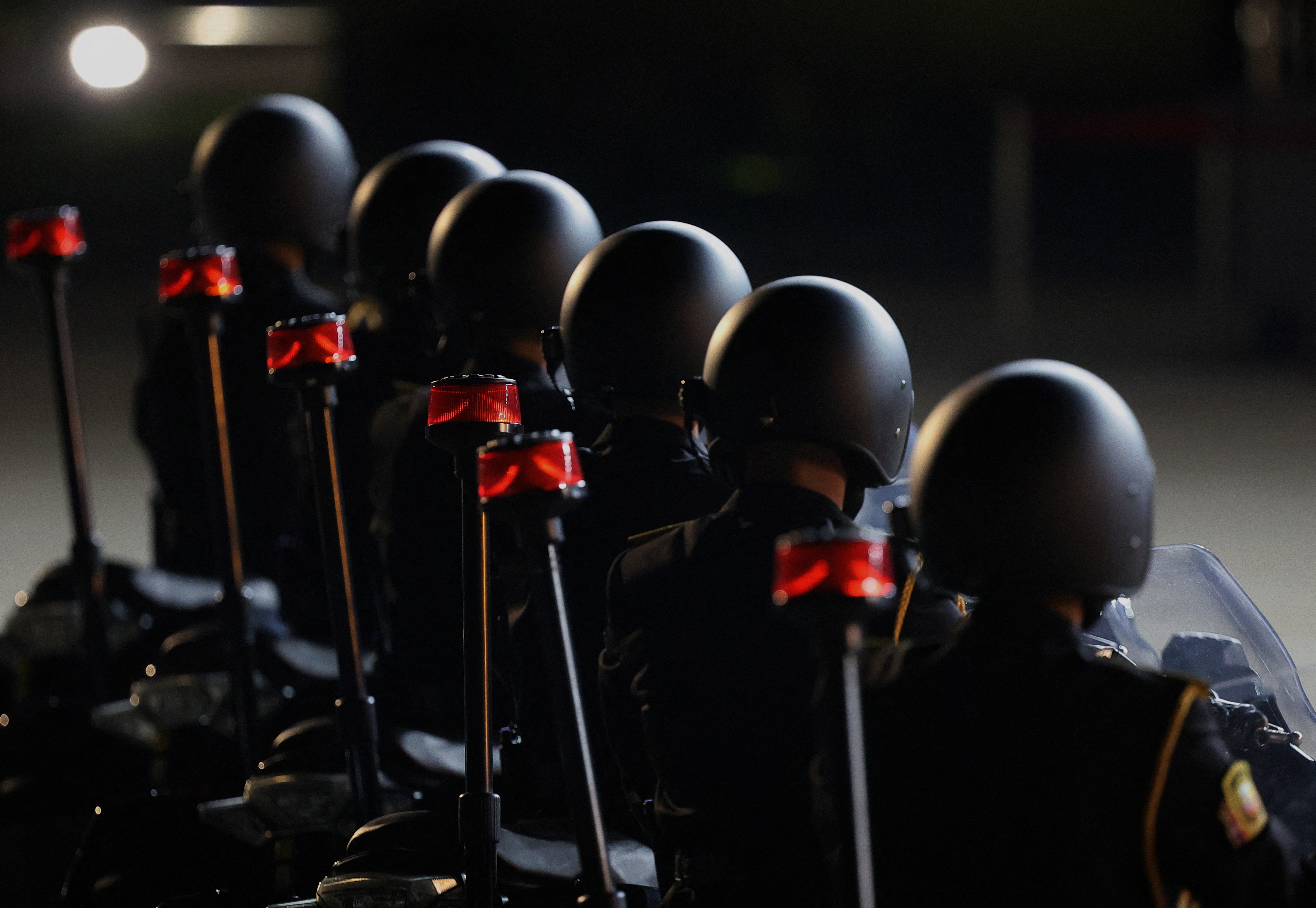 Motorcyclists from the official motorcade. They are in a line.