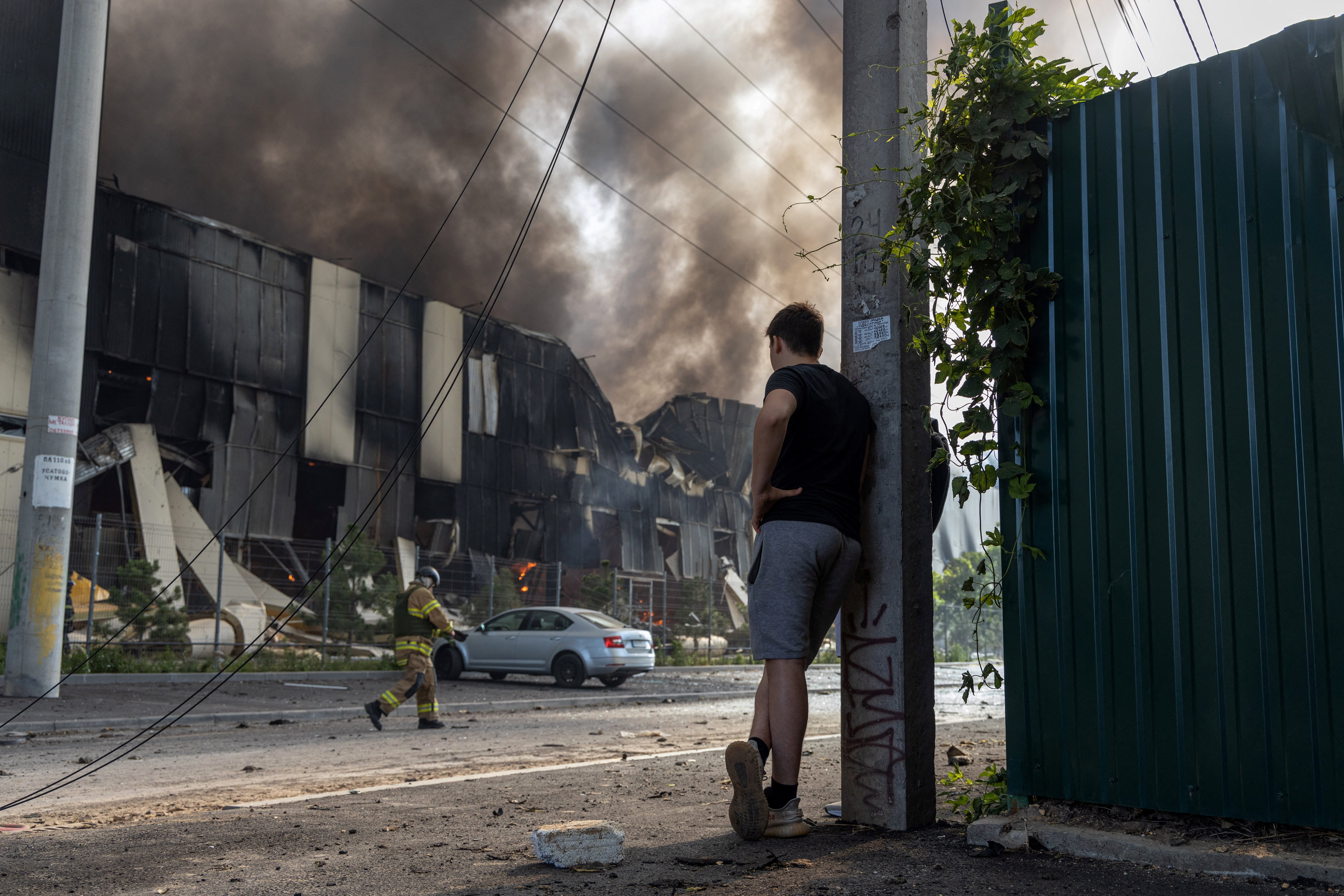 Firefighters work to extinguish a fire at the site of a Russian missile strike in Odesa, on June 24