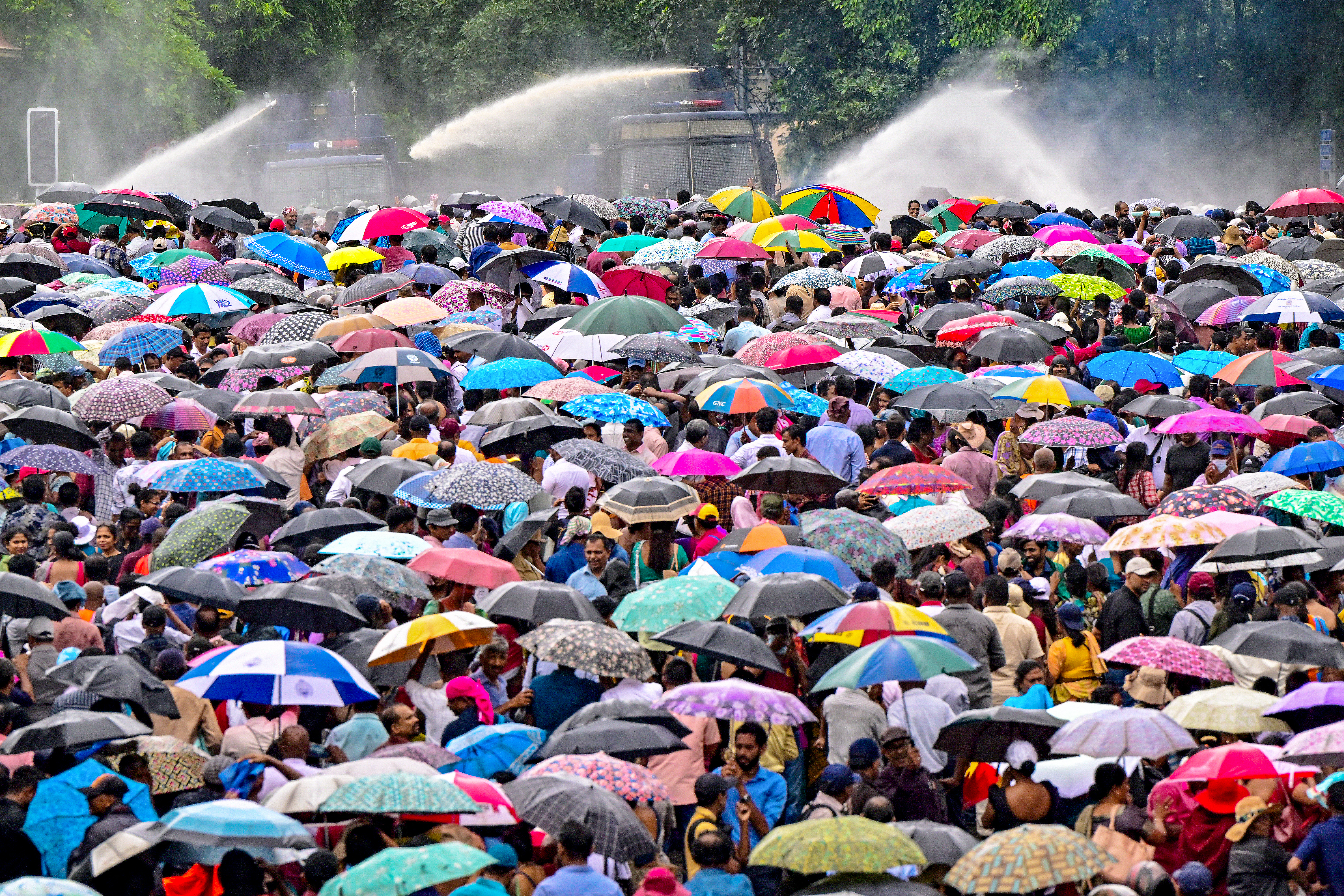 Police use water cannons and tear gas to disperse teachers and principals protesting against salary anomalies during an anti-government demonstration in Colombo on June 26