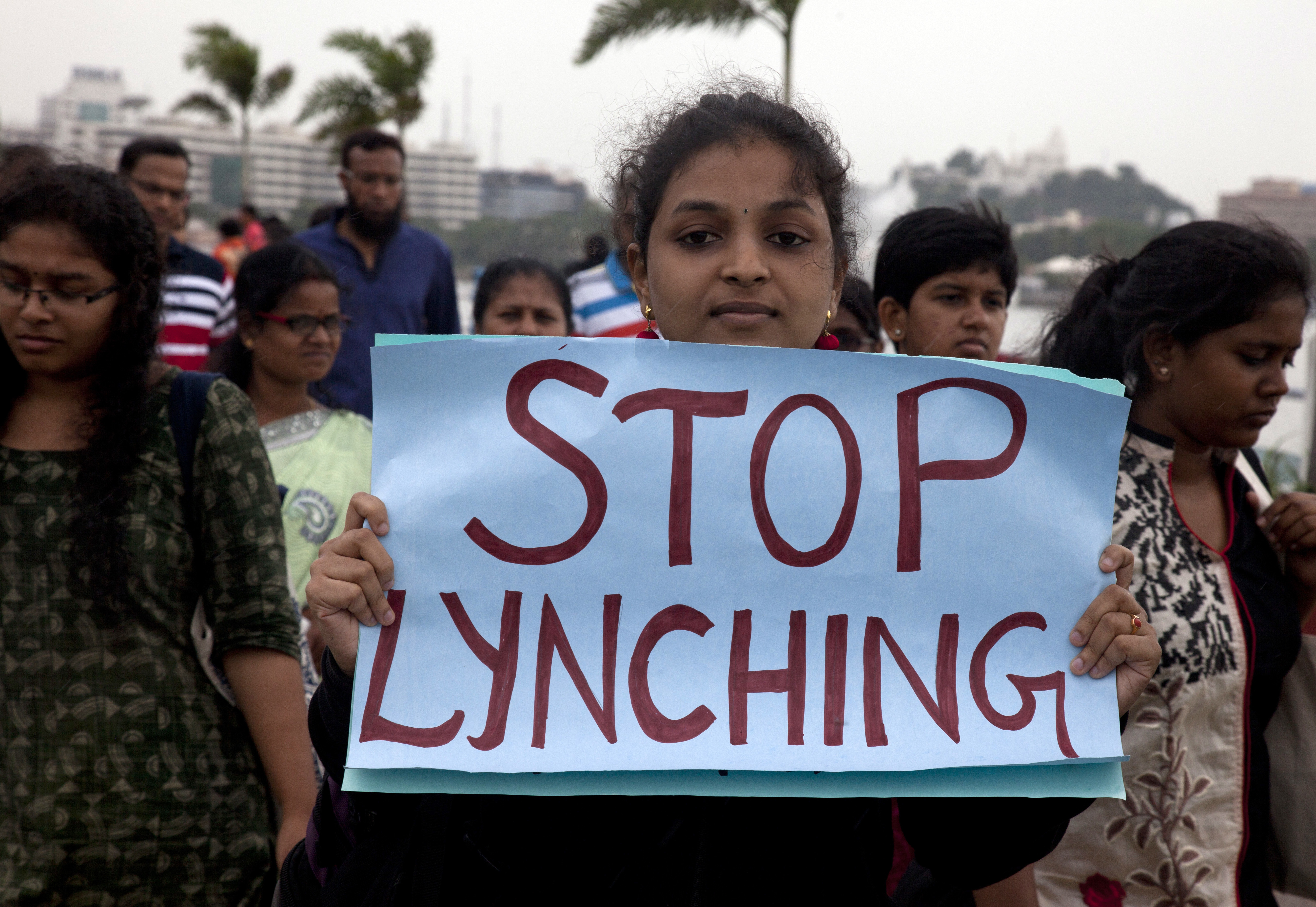 A woman holds a placard and walks to join a protest against a spate of violent attacks across the country targetting the country's Muslim minority, in Hyderabad, India, Wednesday, June 28, 2017. Carrying placards that said "not in my name," the protestors on Wednesday decried the silence of India's Hindu rightwing government in the face of the public lynchings and violent attacks on at least a dozen Muslim men and boys since it came to power in 2014. (AP Photo /Mahesh Kumar A.)