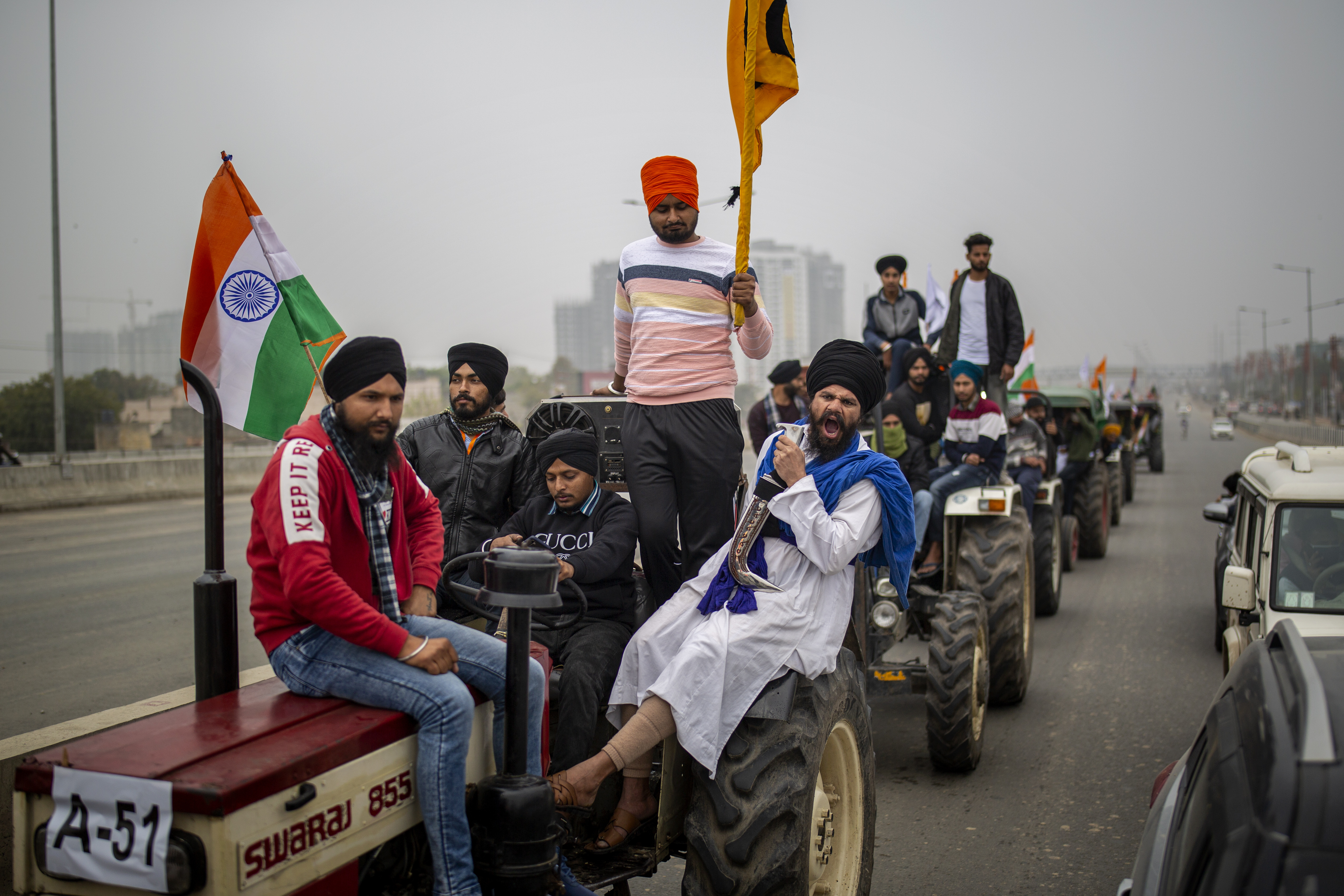 Farmers take out a tractor rally in a protest against new farm laws at Ghaziabad, outskirts of New Delhi, India, Thursday, Jan. 7, 2021. Indian farmers who have blockaded key highways for weeks say they'll continue their protests for new agricultural laws to be repealed. (AP Photo/Altaf Qadri)