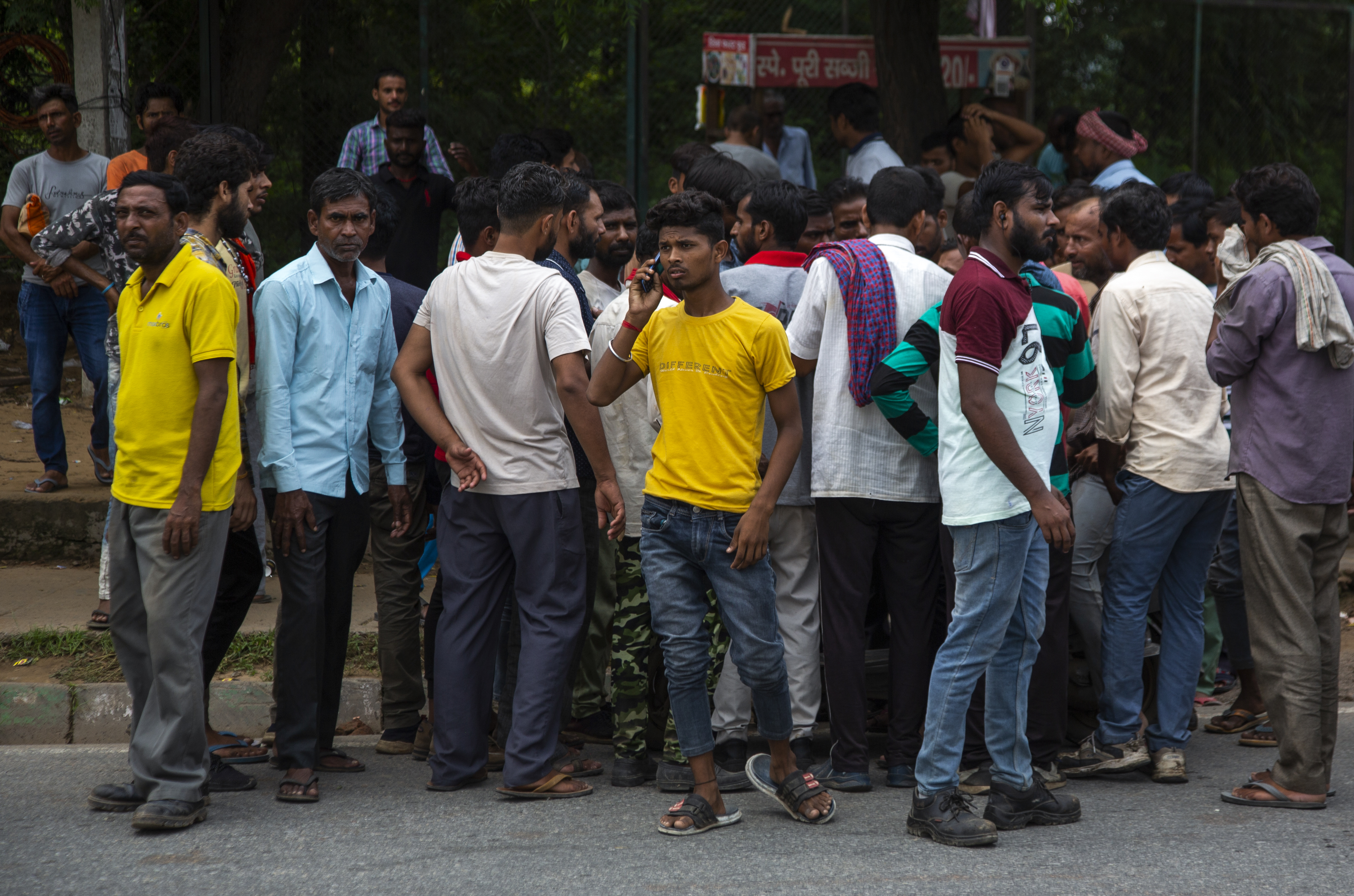 People from northern states crowd the labor chowk - a bazaar at the junction of four roads where hundreds of workers gather daily at daybreak to plead for work in Manesar Industrial Area, Haryana state, India,