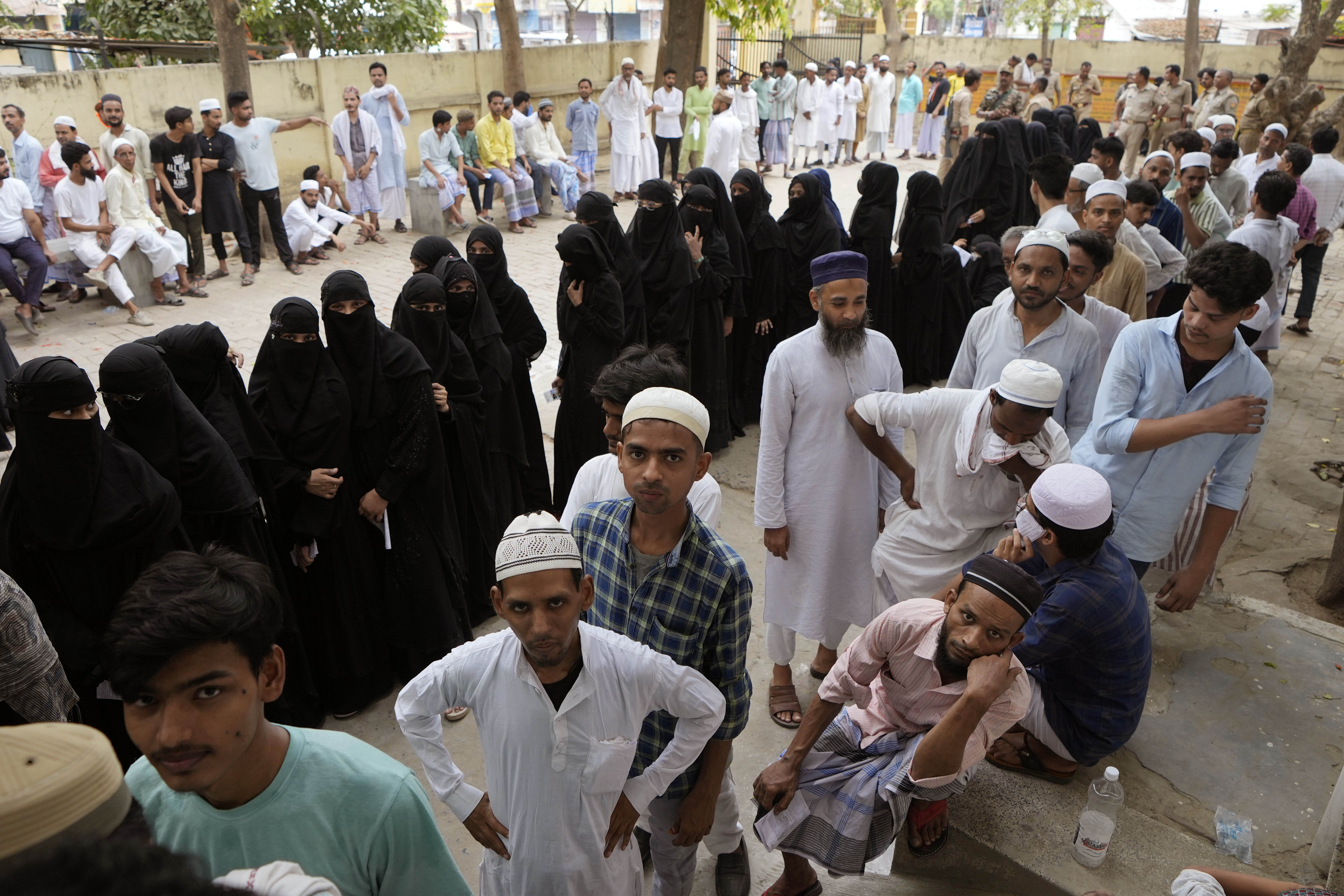 Muslims stand in queues to cast their votes in the seventh and final phase of national elections