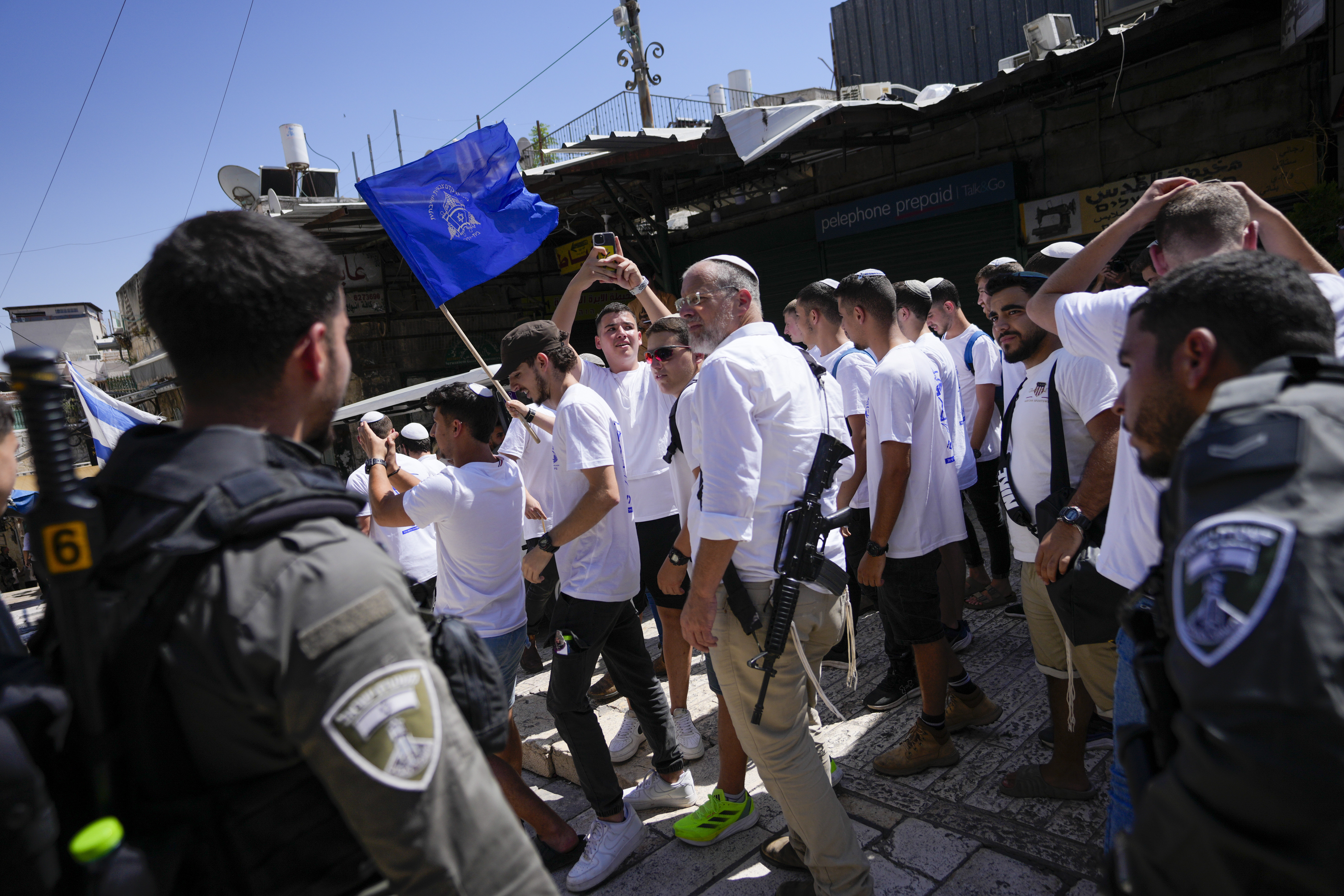 Israelis march through the alleyways of Jerusalem's Old City to the Western Wall, waving Israeli flags on 'Jerusalem Day' to commemorate the establishment of Israeli control over the city.