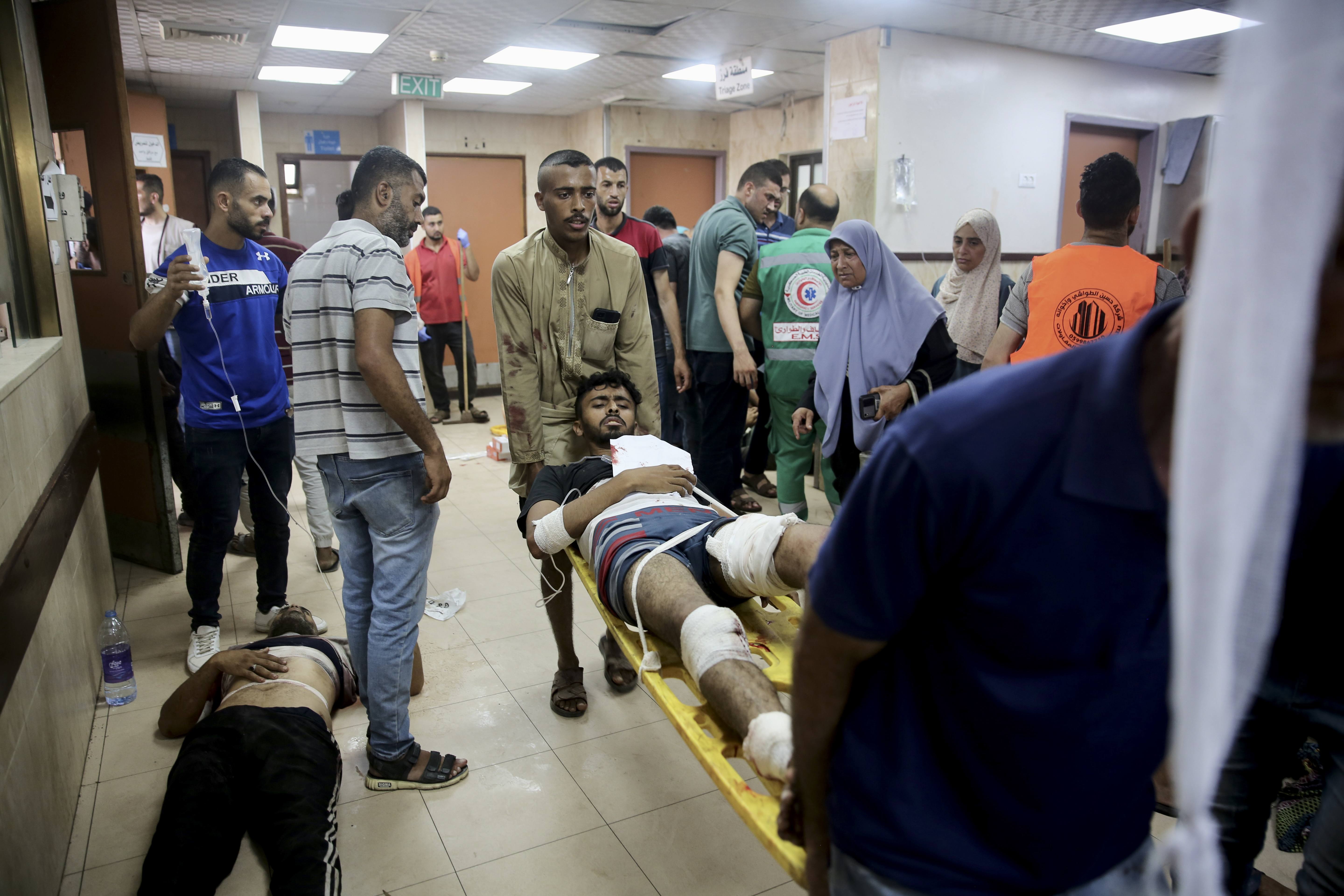 Palestinians wounded in the Israeli bombardment of the Gaza Strip are treated at al-Aqsa Hospital in Deir al Balah on Saturday