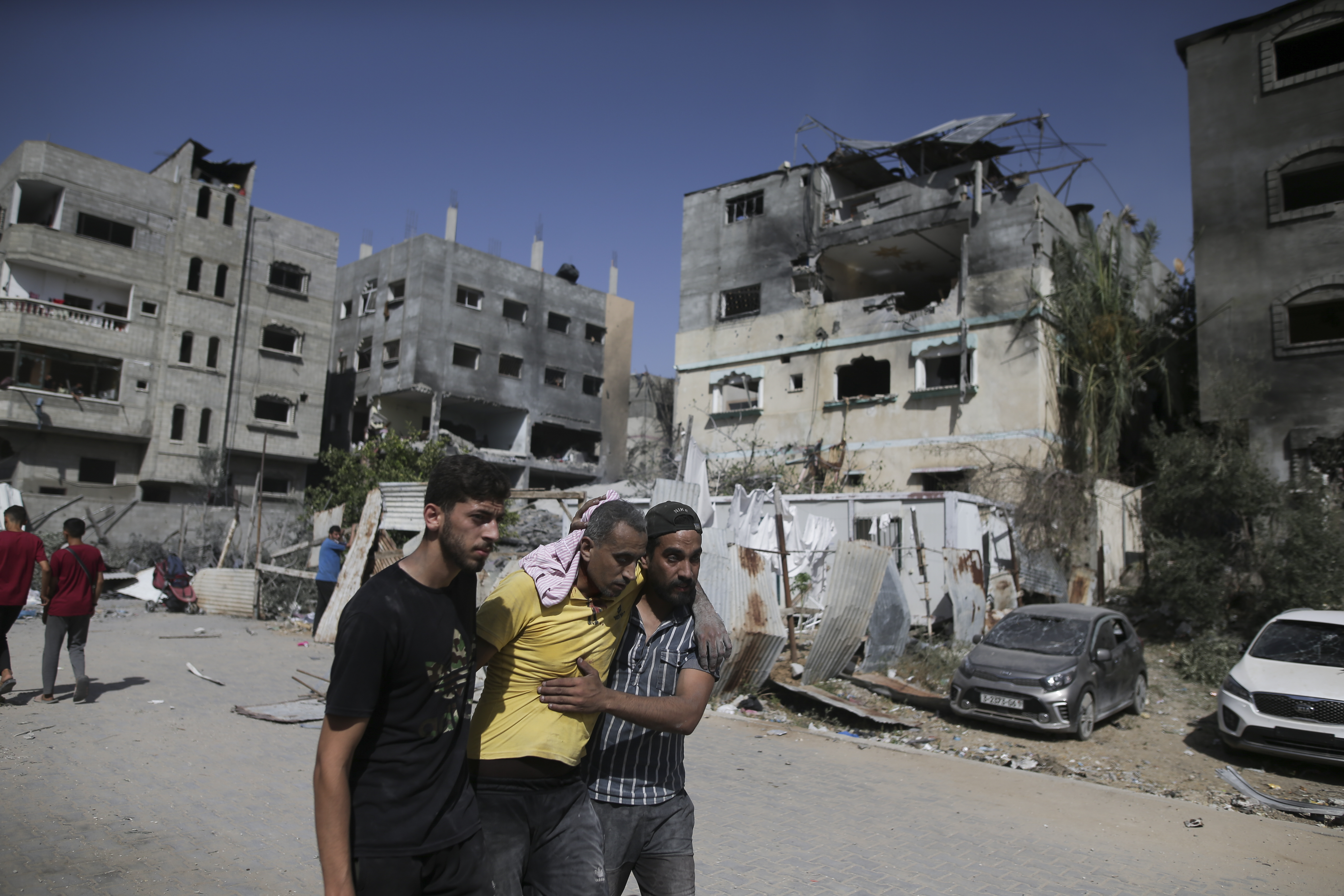 Palestinians help a wounded man after Israeli strikes in Nuseirat refugee camp, Gaza Strip, on June 8,