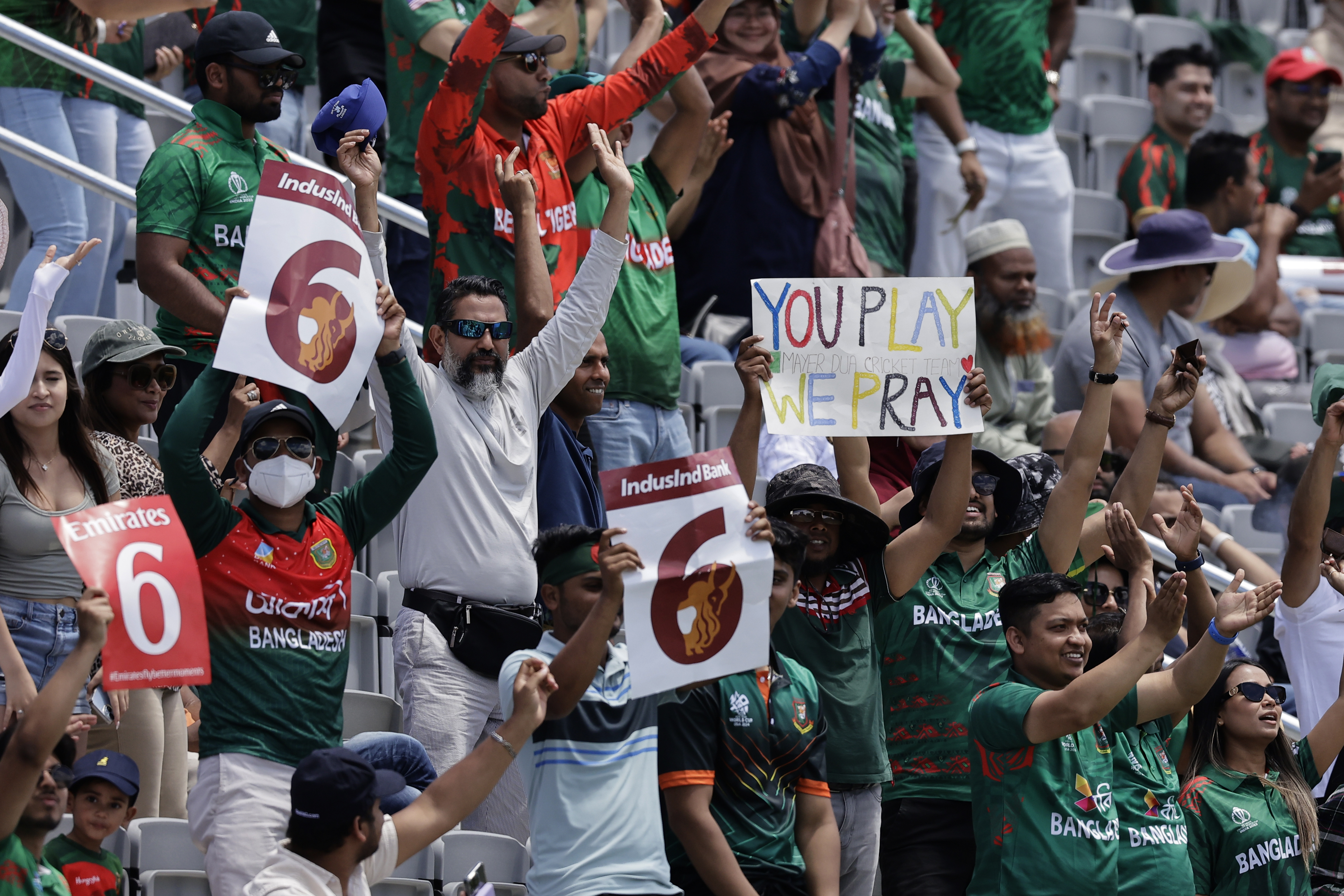 Fans react after Bangladesh's captain Najmul Hossain Shanto hit a six during the ICC Men's T20 World Cup cricket match between Bangladesh and South Africa at the Nassau County International Cricket Stadium in Westbury, New York, Monday, June 10, 2024. (AP Photo/Adam Hunger)