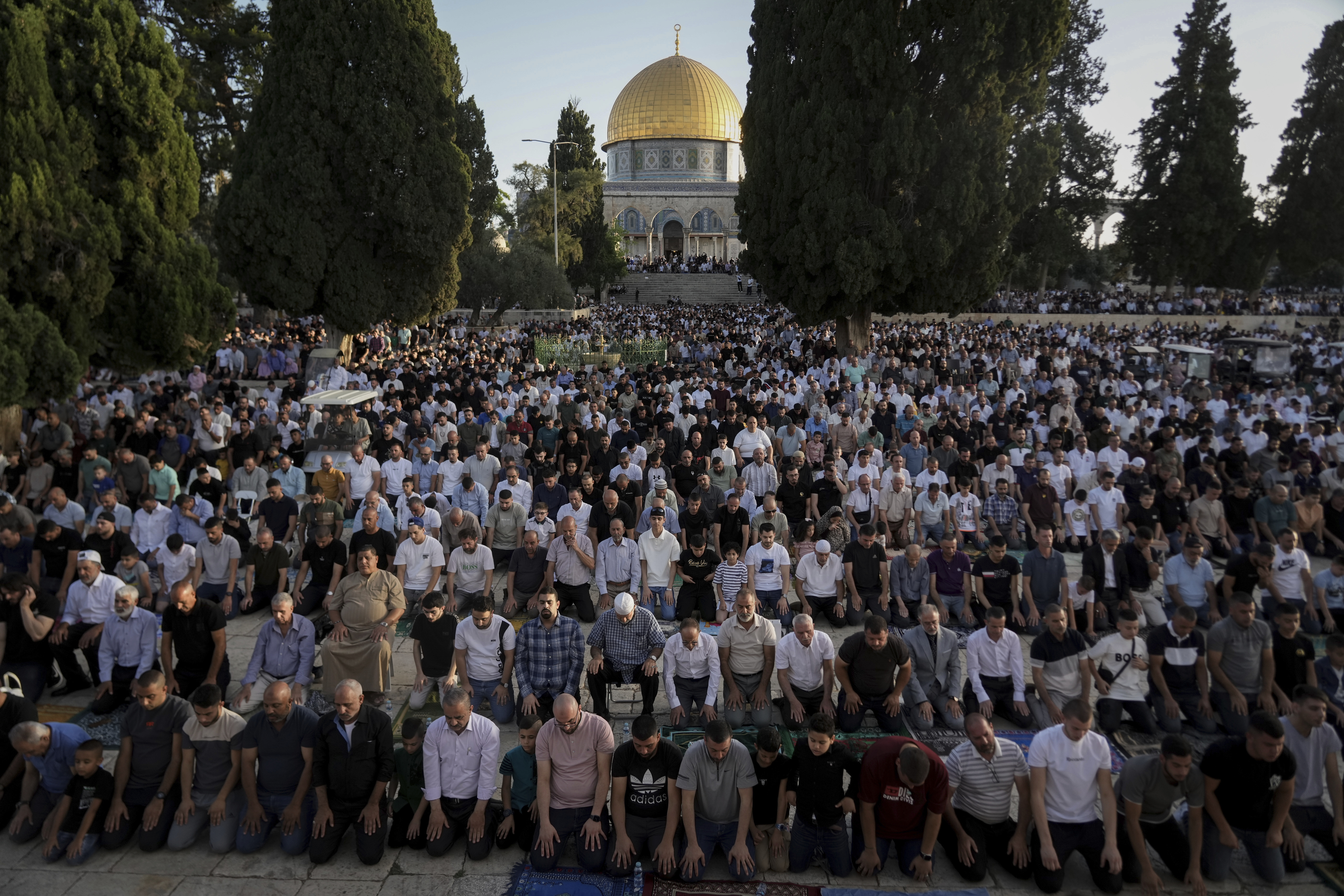 Muslim worshippers offer Eid al-Adha prayers next to the Dome of the Rock shrine at the Al Aqsa Mosque compound in Jerusalem's Old City, Sunday, June 16
