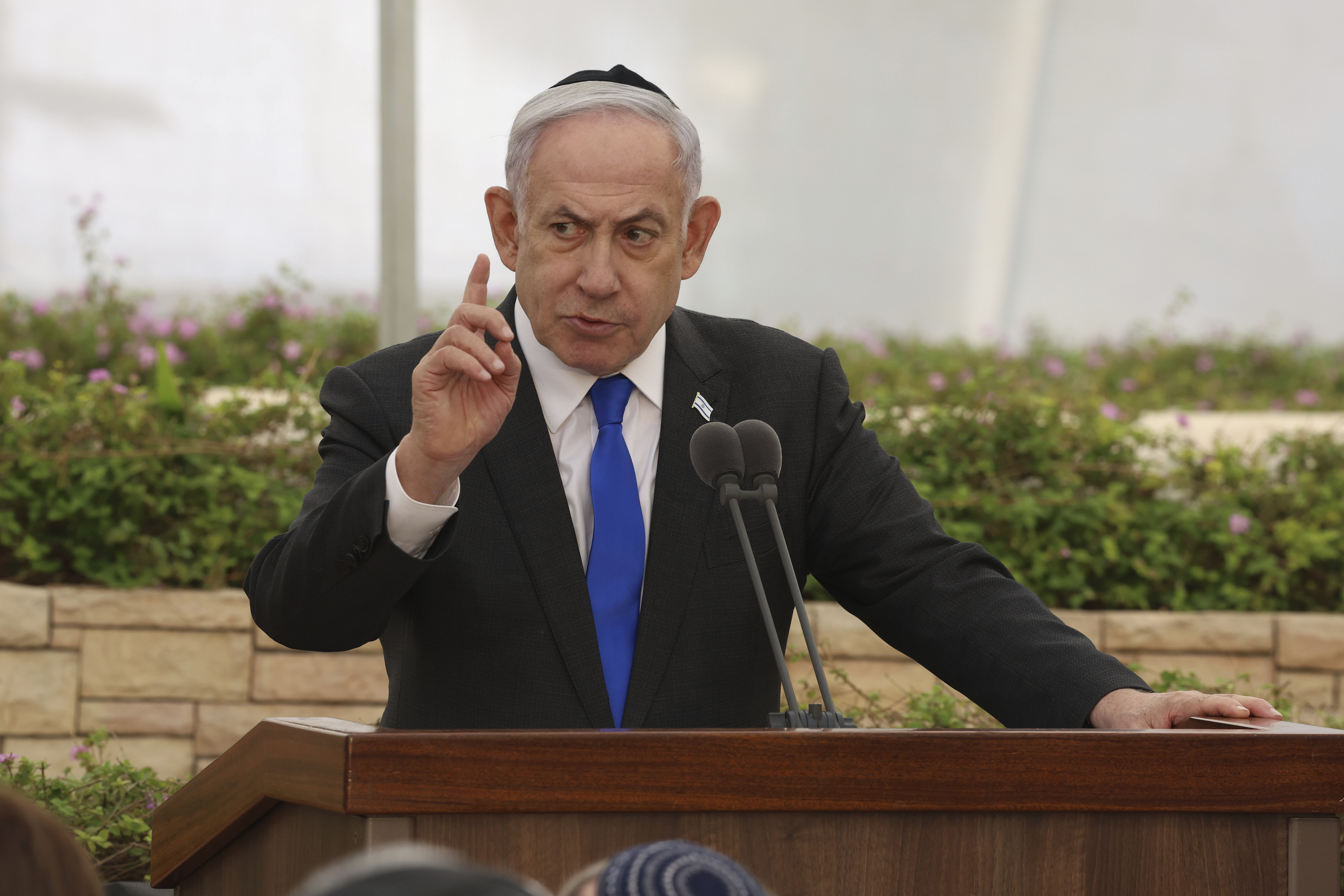 Israeli Prime Minister Benjamin Netanyahu speaks during a ceremony at the Nahalat Yitshak Cemetery in Tel Aviv